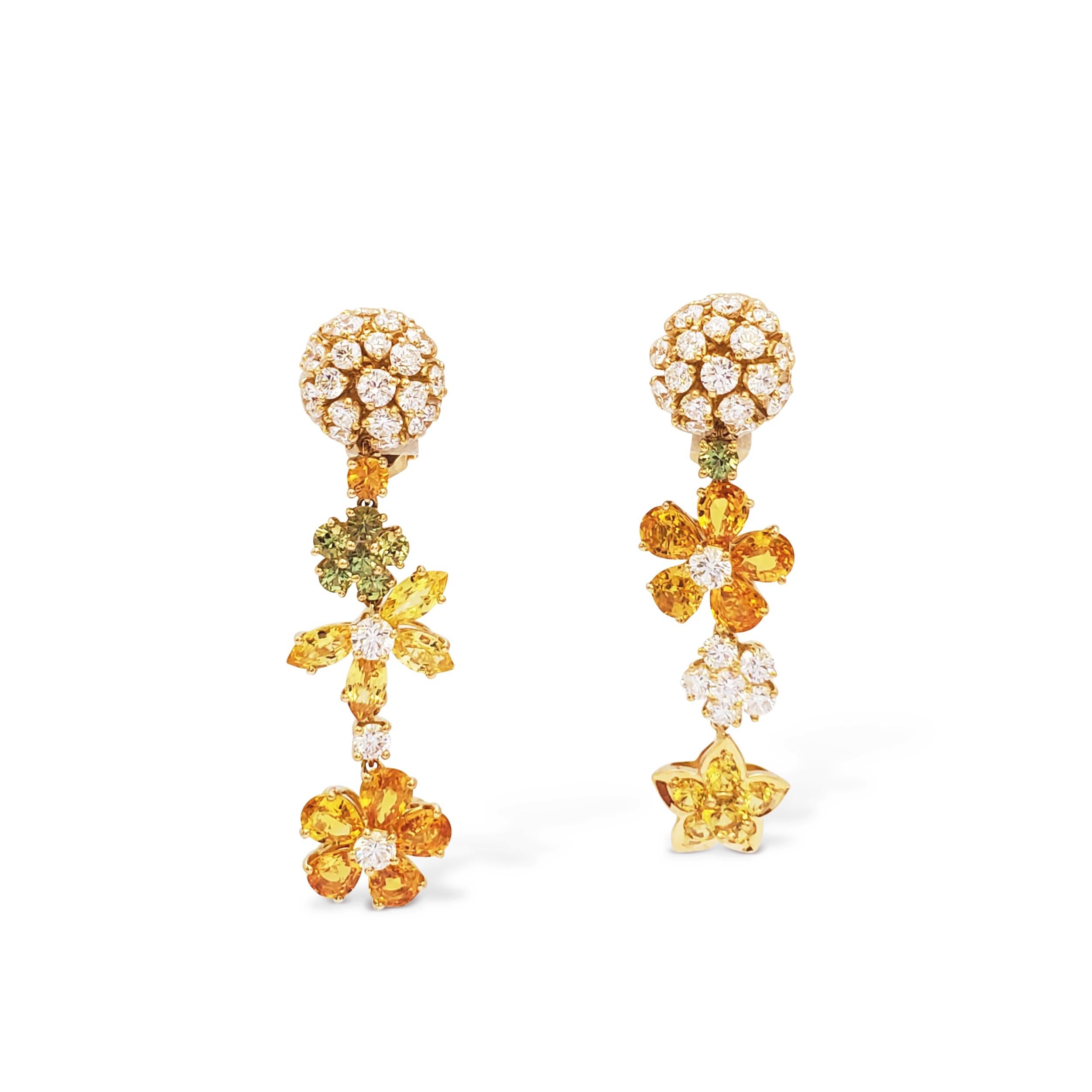 Authentic Van Cleef & Arpels Folies des Prés ear clips crafted in 18 karat yellow gold.  The dangle earrings feature a captivating mix of diamonds and sapphires in varying shapes, sizes, and colors arranged in a floral design.  

Set with round cut