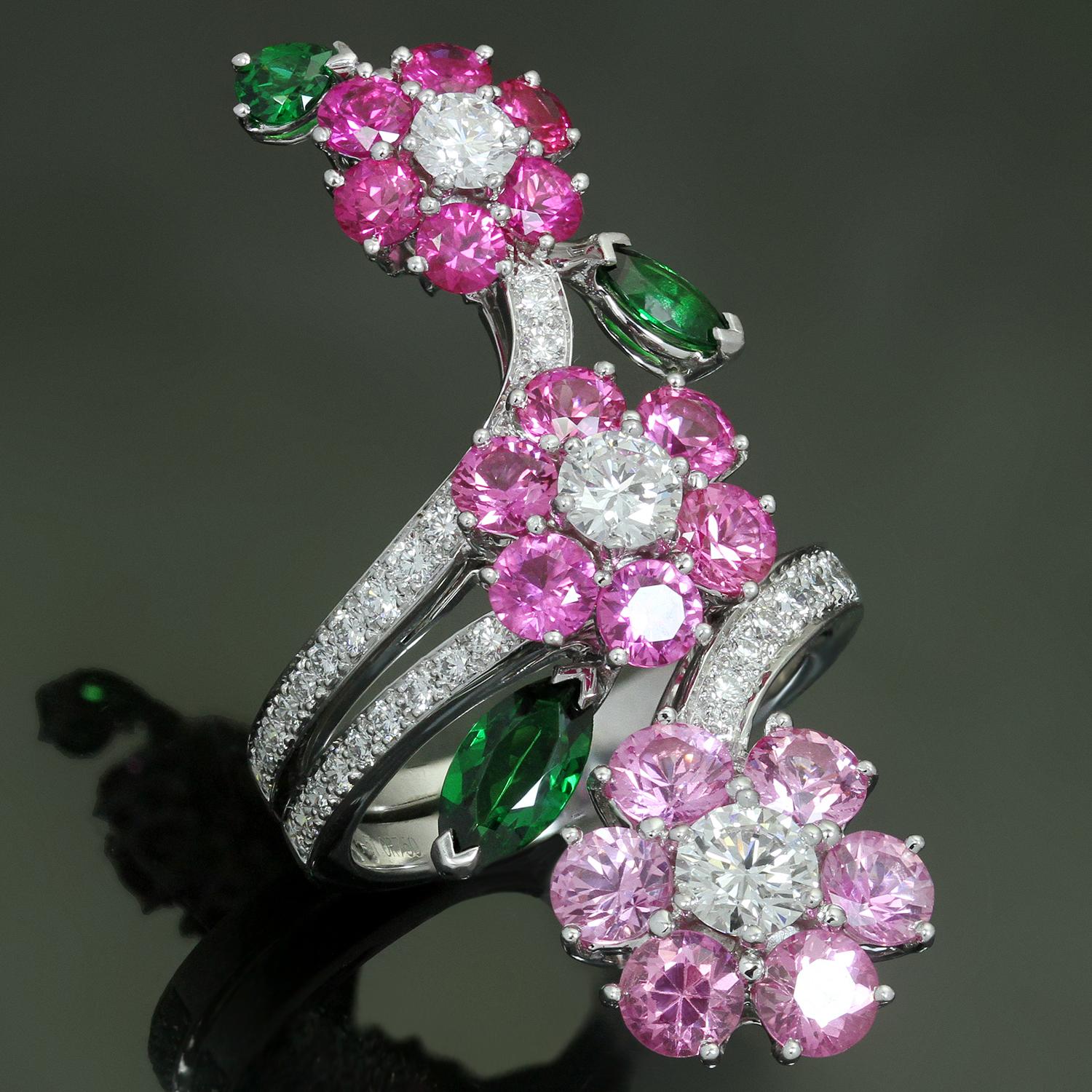 This magnificent 3-flower ring from Van Cleef & Arpel's Folie des Pres collection is crafted in 18k white gold and features 18 pink sapphire petals in different shades of pink weighing approximately 3.0 carats, 3 vivid green tsavorite leaves of an