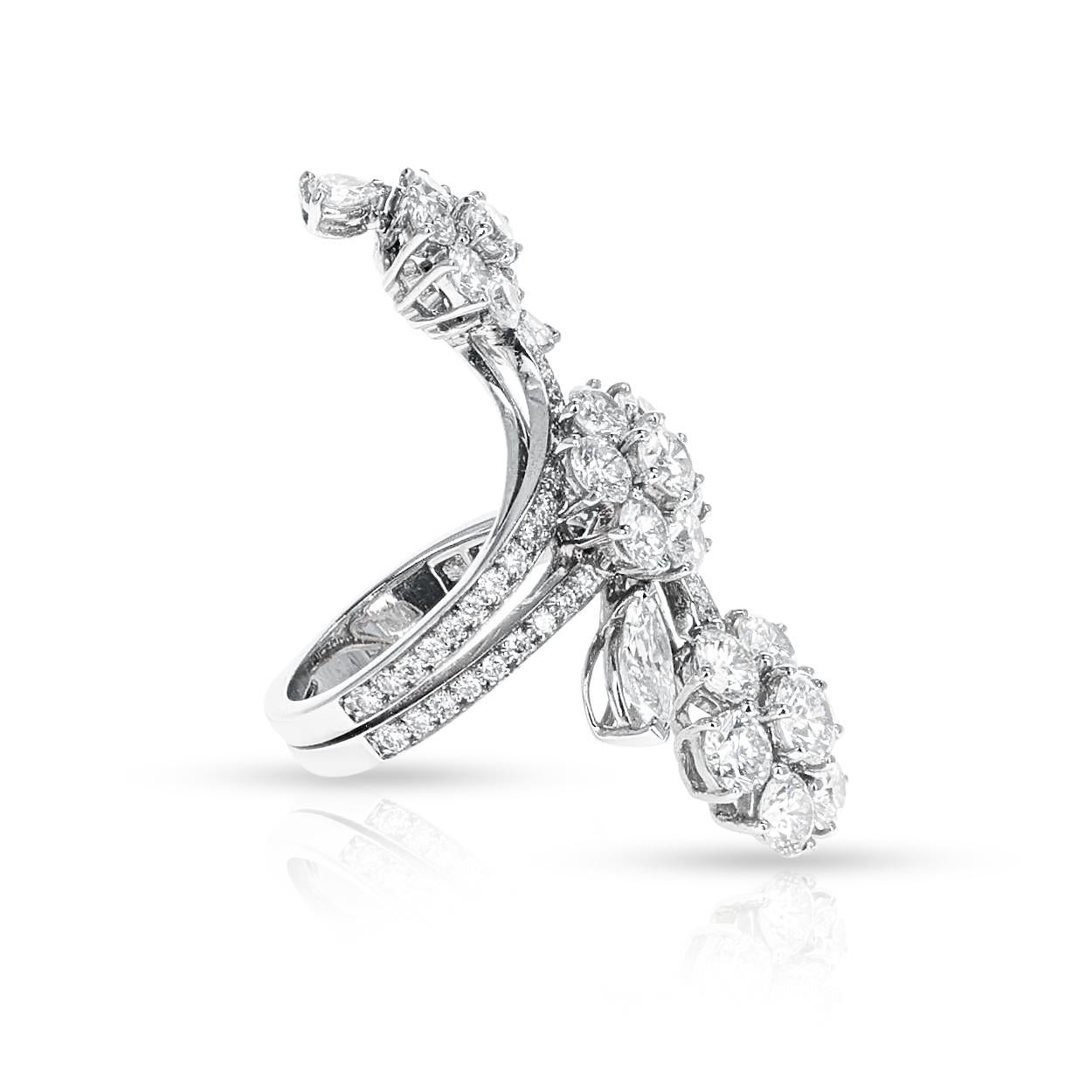 A Van Cleef & Arpels Folie Des Pres Ring. There are pear, marquise and round shape diamonds in a floral-trio design. Made in 18k White gold. Ring Size US 6. Total weight 10.25 grams.

SKU: 1164