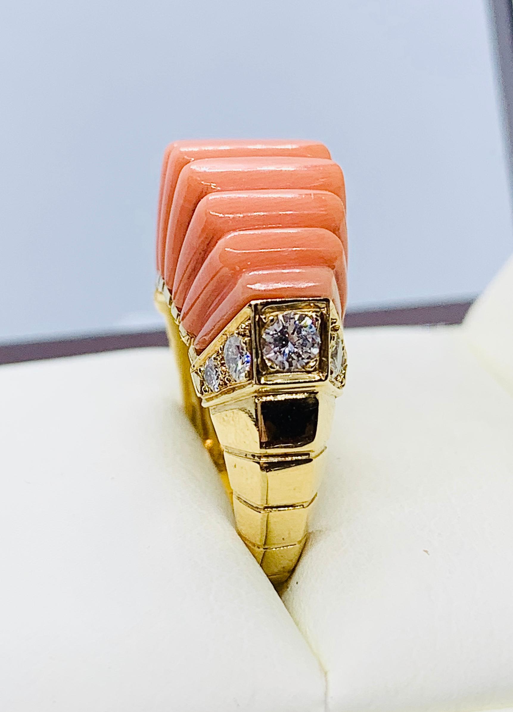 Absolutely Gorgeous Van Cleef & Arpels France Ring! This is a vintage piece that is made in 18K yellow Gold. This is a numbered piece that features a carved coral band that measures one inch end to end and just under 1/2 inch wide. It rises 1/2 inch