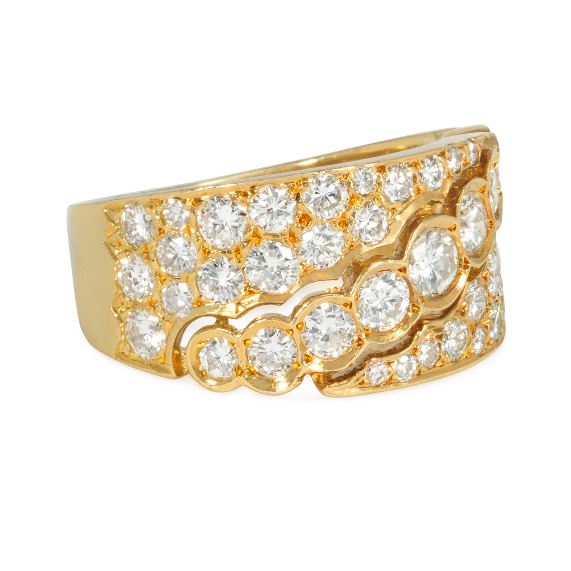 A late 20th-century gold and diamond band-style ring, the pierced and tapered pavé diamond face bisected diagonally by a graduated line of collet-set diamonds, in 18k. Van Cleef & Arpels, France. #C5305 A5

Minor re-sizing possible - please contact