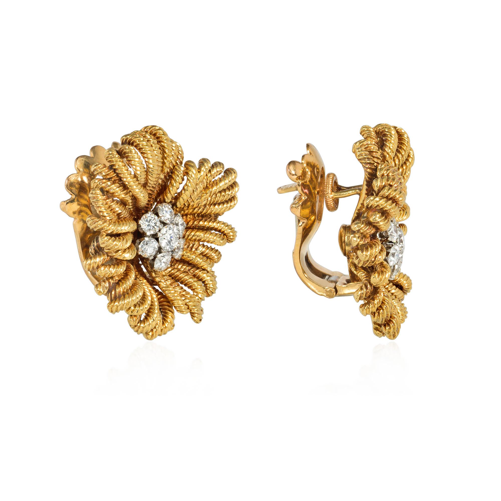 A pair of mid-century gold and diamond clip earrings designed as stylized flowers with reeded gold wire petals and diamond cluster centers, in platinum and 18k. Van Cleef & Arpels, Paris, #81115. Maker's mark for Pery et Fils. Atw diamonds 0.86