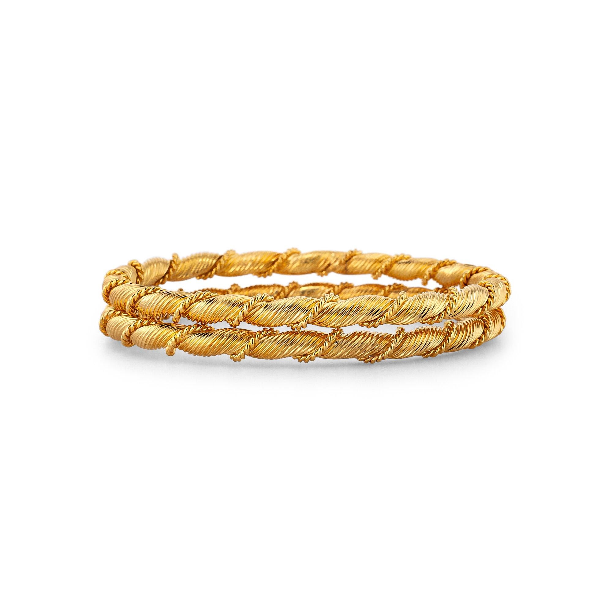 This pair of Van Cleef & Arpels France vintage twisted yellow gold bangle bracelets will always give you the double exposure you crave. Signed VCA France with serial numbers 2V7756 and 2V7747. Circa 1970.  18 karat yellow gold.  Size medium. 
