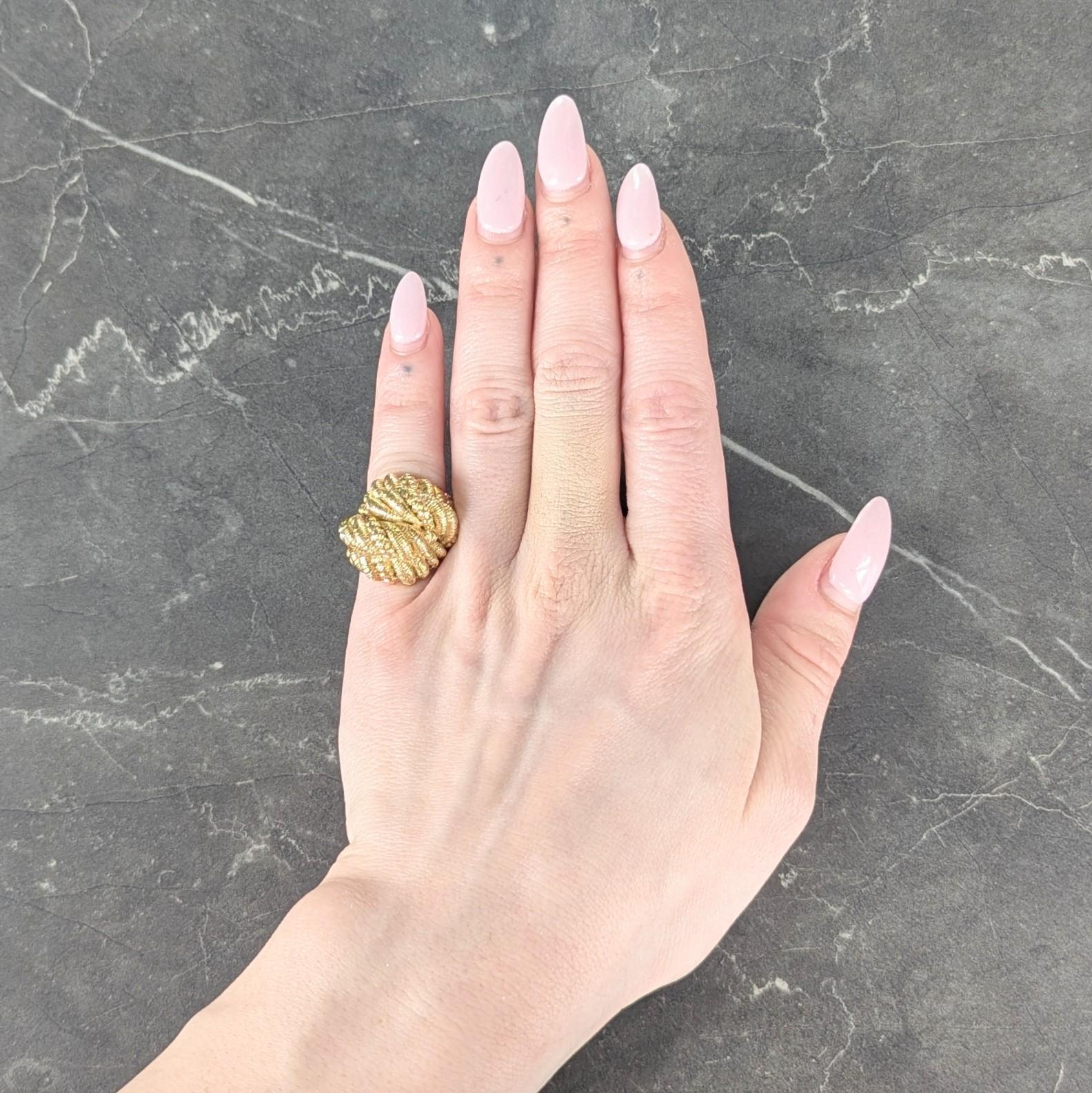 Designed as a domed form with fluted twisted rope motif segments
Engraved with linear texture and tied as a knot
With high polish finish
Stamped for 18 karat gold
Numbered and fully signed for Van Cleef & Arpels, France
Circa: 1960s
Ring size: 3 3/4