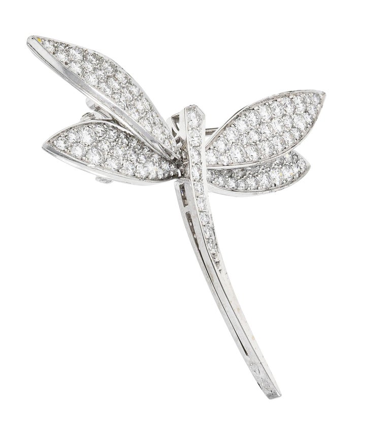 Brooch is designed as a stylized dragonfly with four wings and sleek body. With round brilliant cut diamonds bead and pavé set throughout. Weighing approximately 2.00 carats total - G/H in color with VS1 clarity. Completed by hinged pin stem with