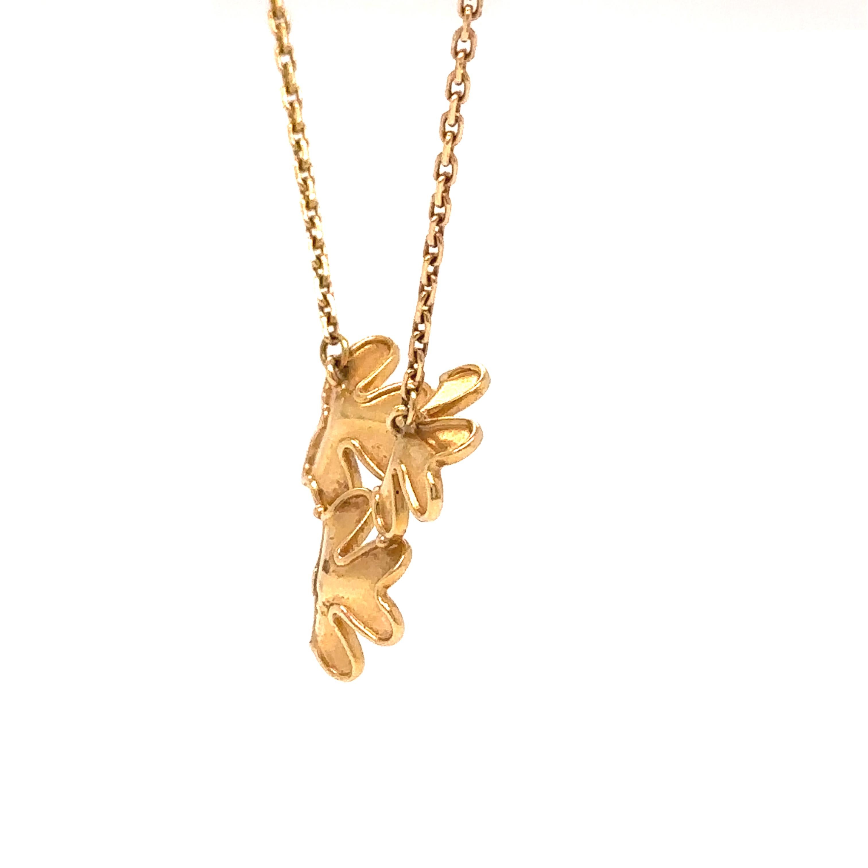 A delicate and elegant Van Cleef & Arpels Frivole Pendant, featuring three miniature floral motifs crafted in 18ct yellow gold and set with dazzling diamonds. This exquisite piece embodies the maison’s signature light-reflecting design, capturing