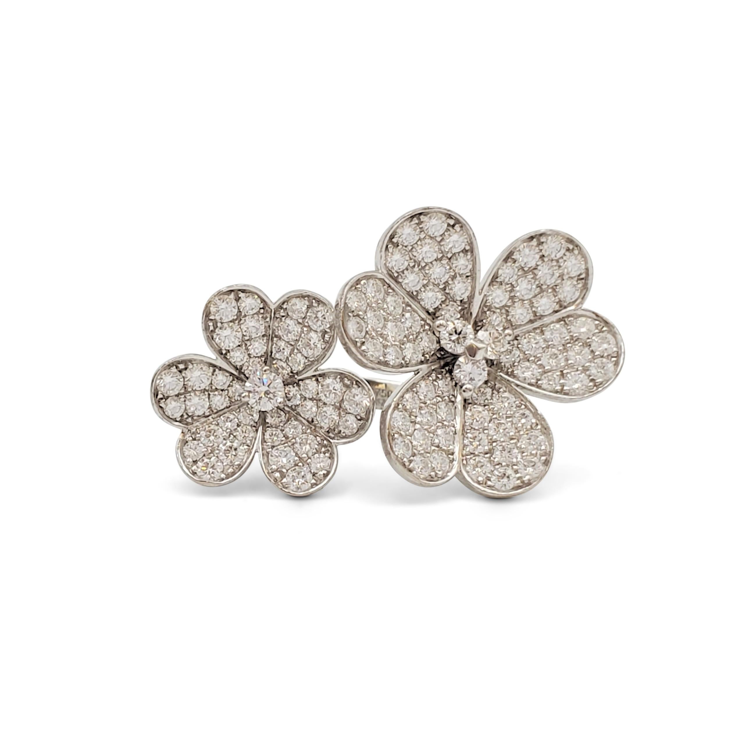 Authentic between-the-finger ring from Van Cleef & Arpels 'Frivole' collection features a two flower design crafted in 18k white gold and set with an estimated 2.10 carats of round brilliant cut diamonds (E-F, VS). Signed VCA, G750, 50, with serial