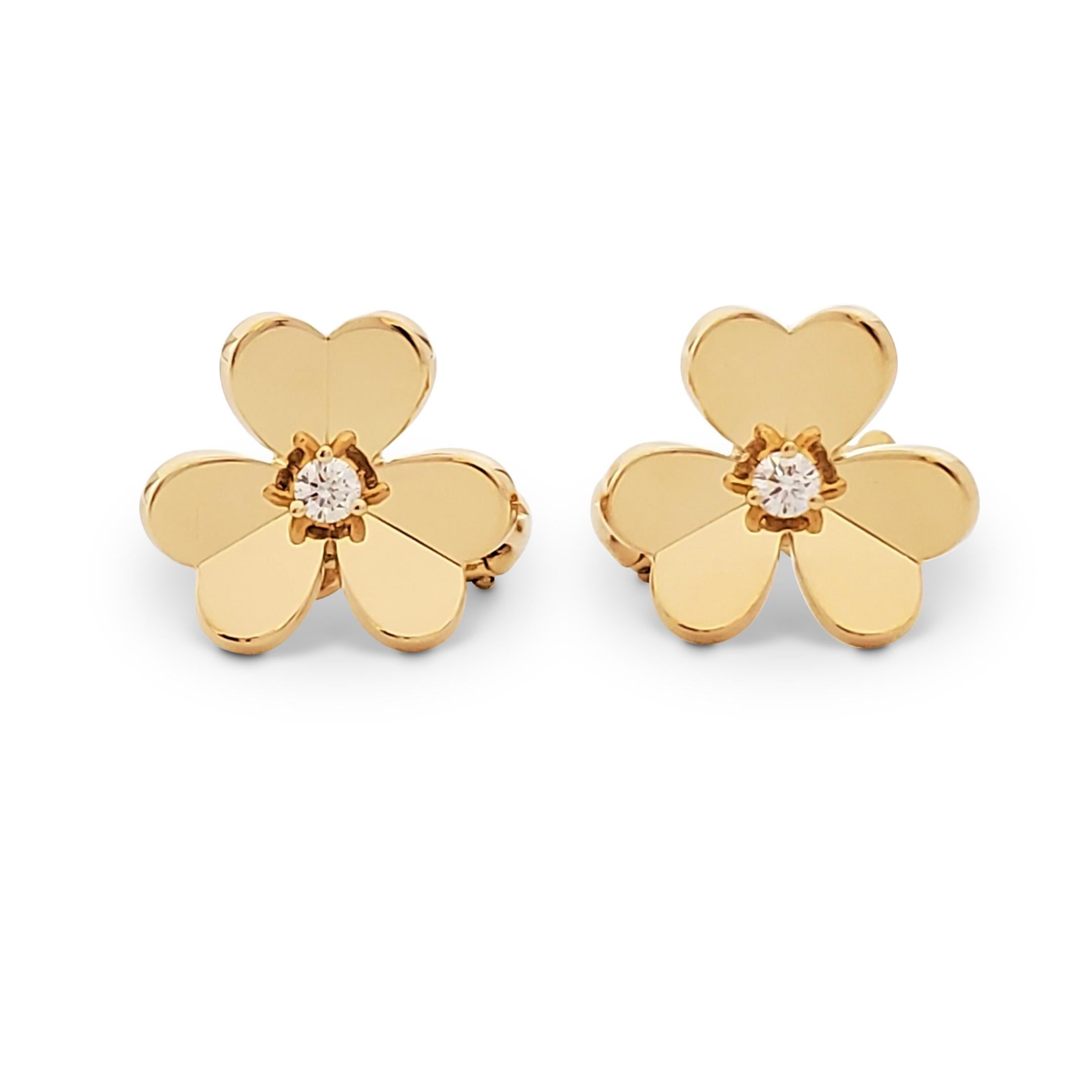 Authentic Van Cleef & Arpels 'Frivole' earrings feature mirror-polished 18 karat yellow gold heart-shaped petals set with a round brilliant cut diamond at the center (0.17 carats total, E-F color, VS clarity). Signed VCA, Au750, with serial number