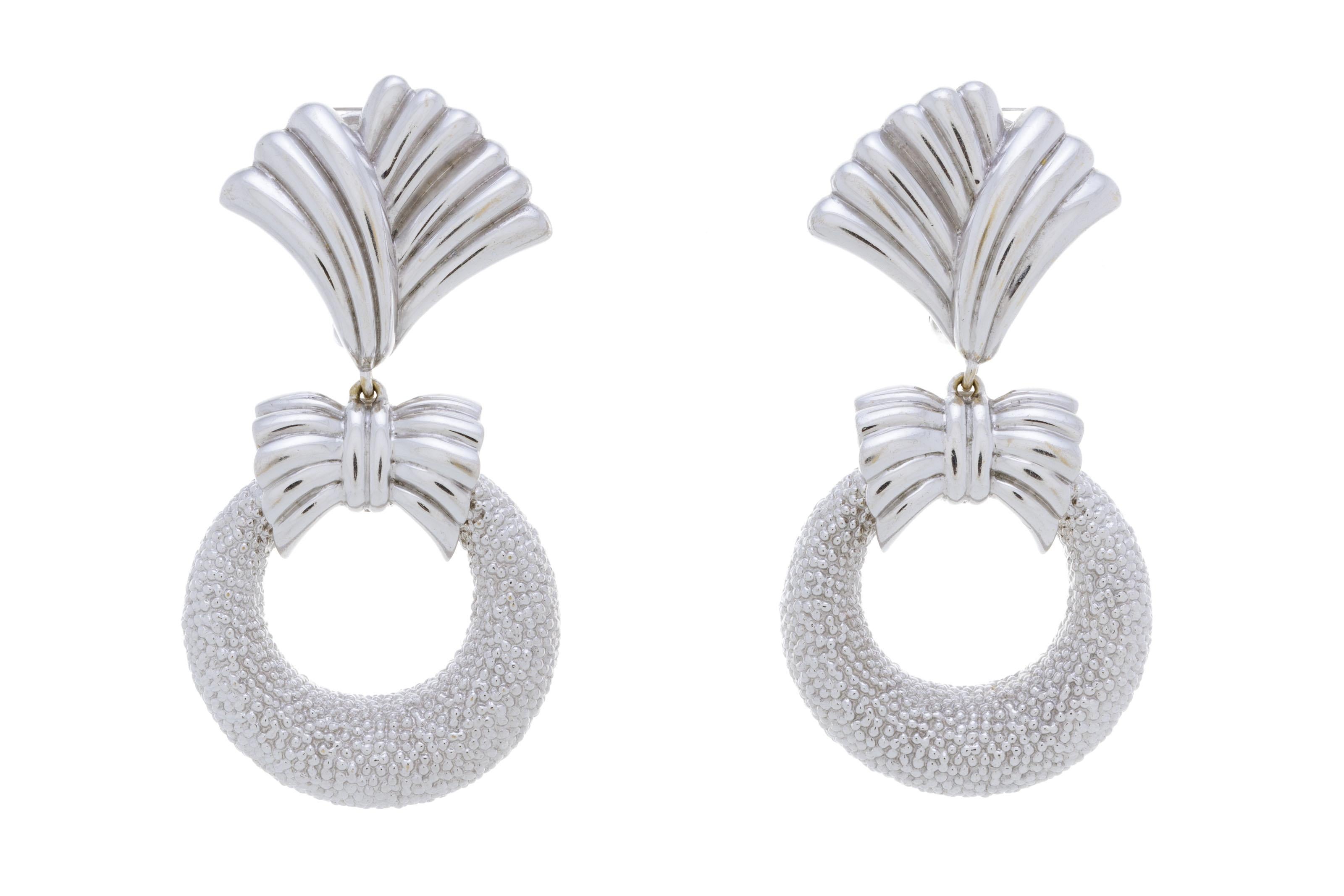 Presenting a rare marvel from Van Cleef & Arpels, these 5-in-1 earrings redefine opulence. A fixed white gold ear piece, 5.5 cm in height, anchors the design. Below it, interchangeable loops in hammered white gold, turquoise, mother of pearl,