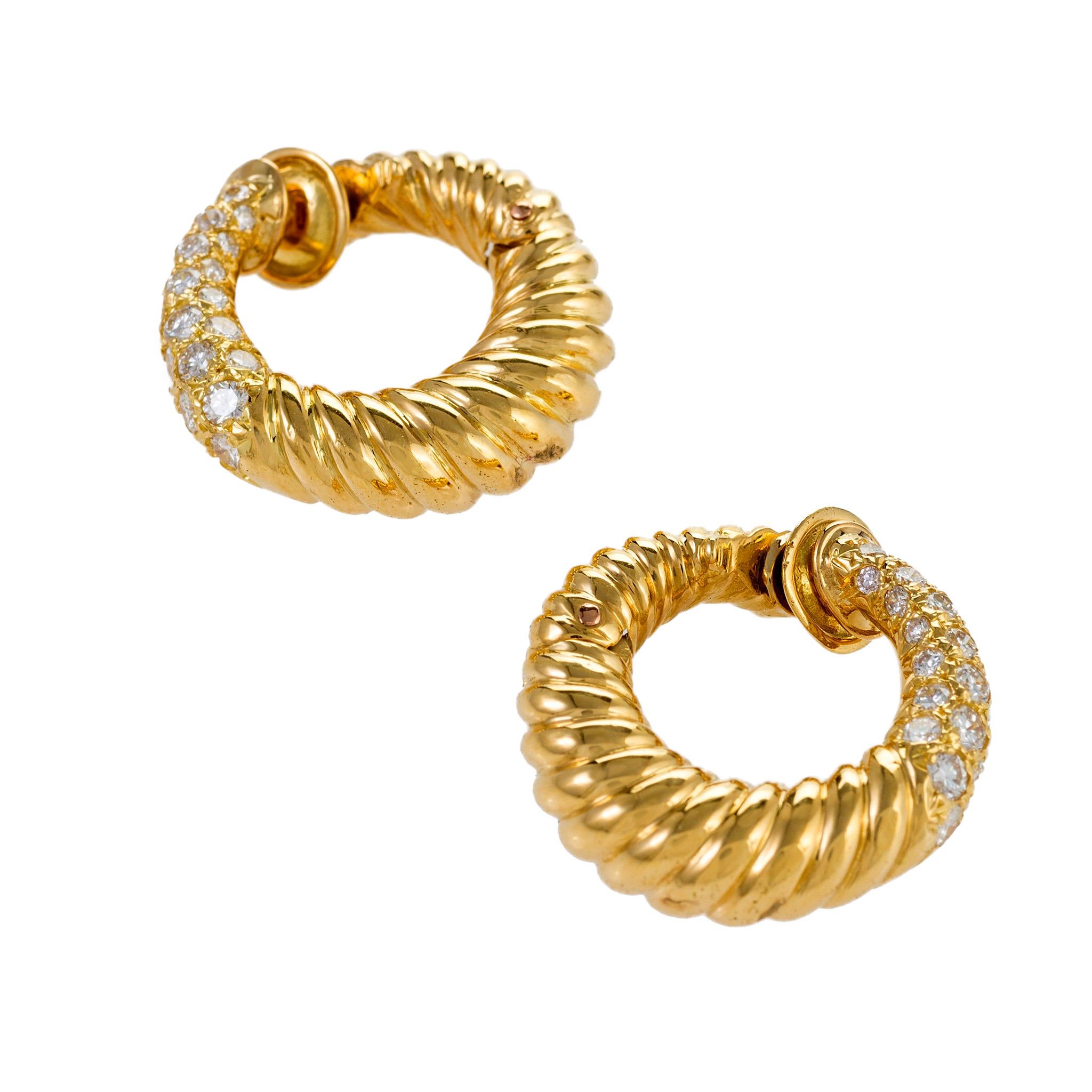These gold and diamond hoop earrings by Van Cleef & Arpels Paris present an ever-popular form with a sparkling twist. A smaller, lighter version of the classic earring design, these beautifully-modeled and stylish twisted hoops clip and angle close
