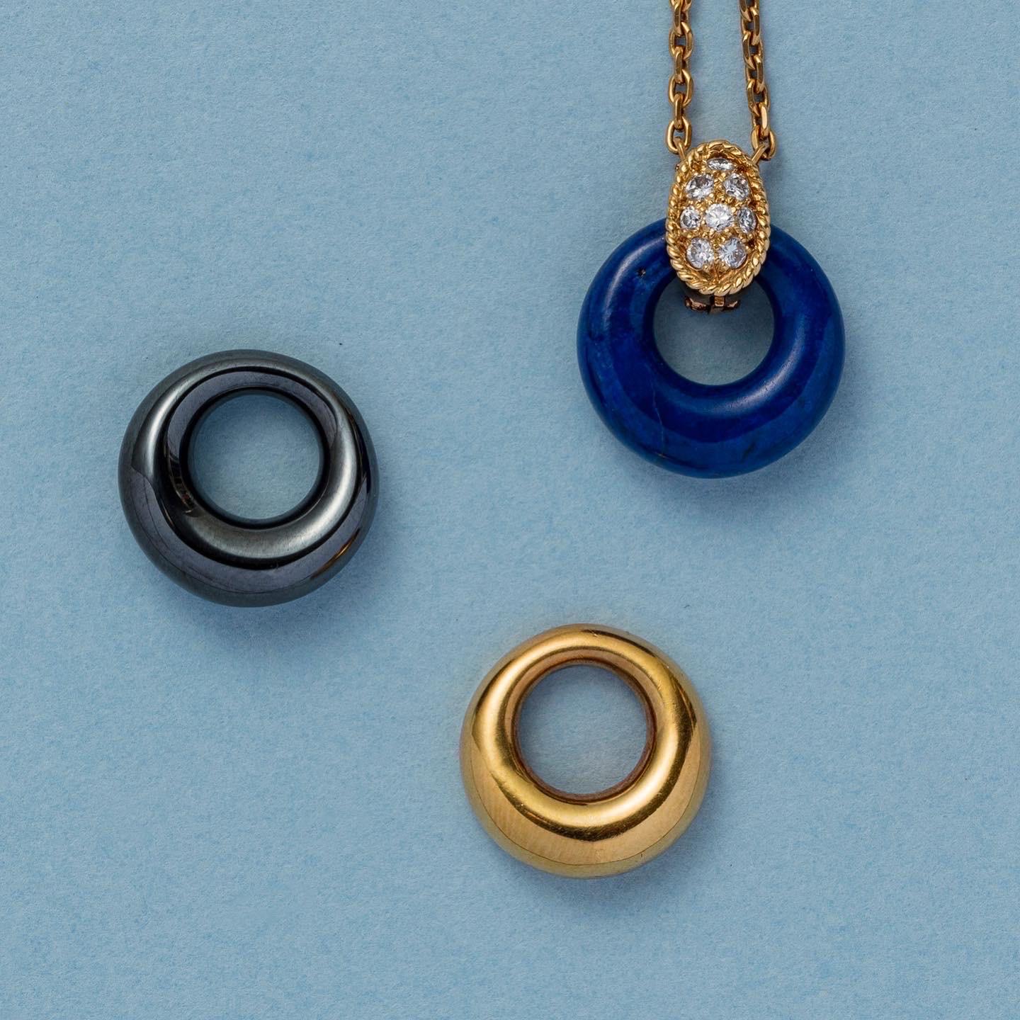 A super rare pendant version of the VCA Philippine collection. An 18 carat gold and diamond pendant with three interchangeable discs, one gold, one lapis and one hematite, signed and numbered: Van Cleef & Arpels, B4140A487, model: Philippine with