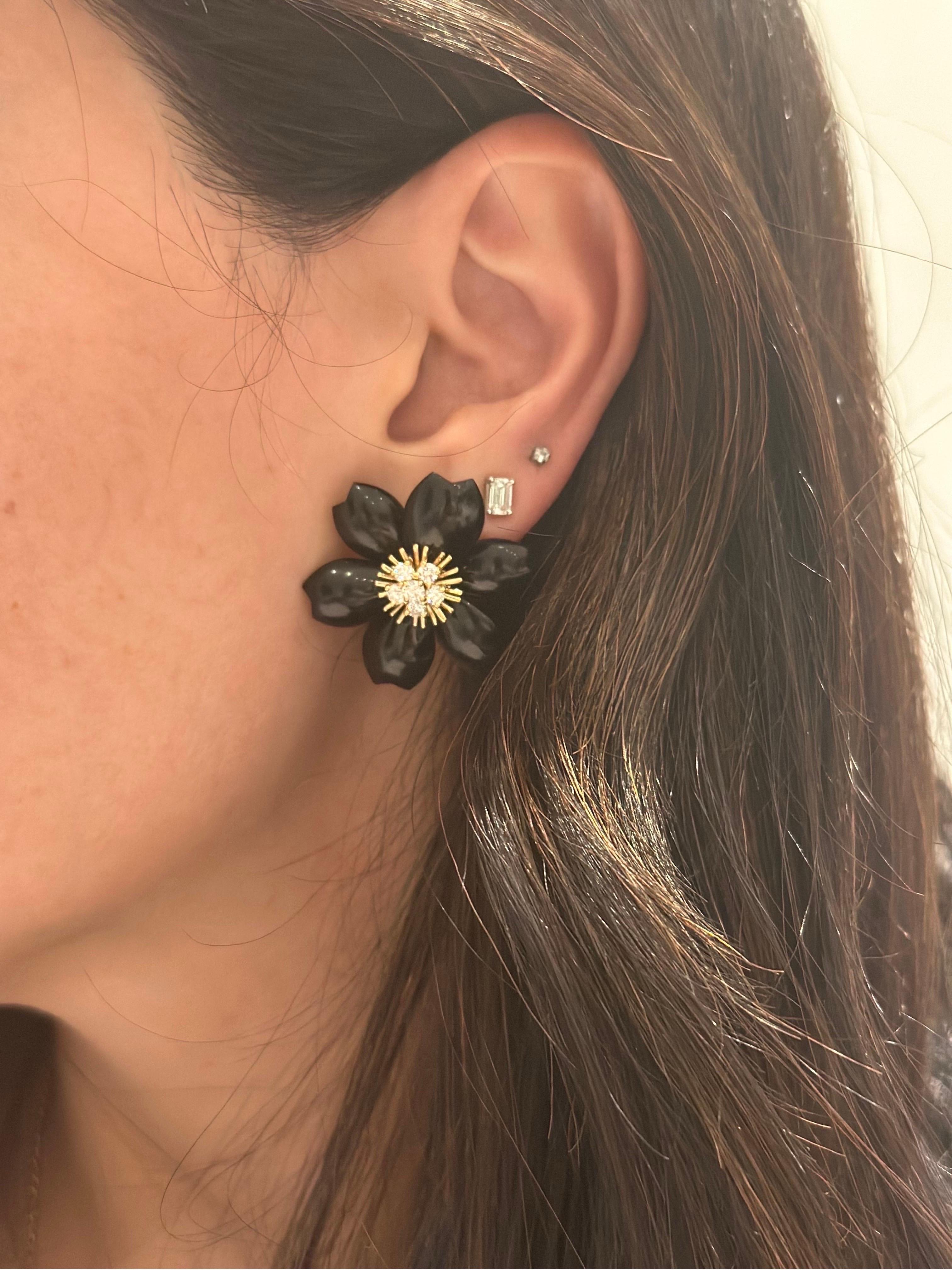 Van Cleef & Arpels Pair of Gold, Onyx and Diamond 'Rose de Noel' Ear-clips, France, crafted in 18k yellow gold, each flower consists of six onyx petals, centered with a floret of 6 round brilliant cut diamonds. 12 Diamonds, total weight ap. 1.05 ct.