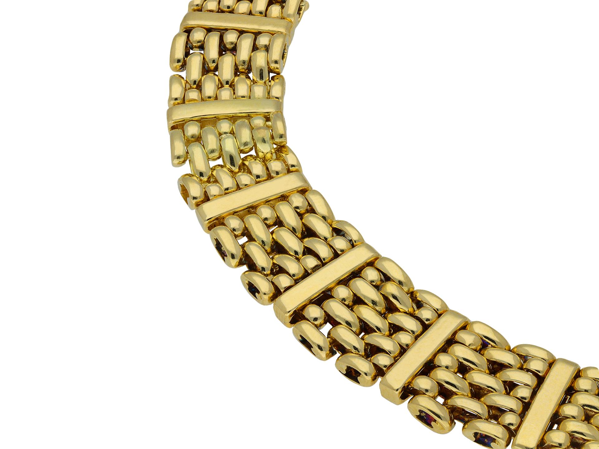 Van Cleef & Arpels gold bracelet. A yellow gold articulated bracelet comprised of sixteen sections of seven rows of horizontal tubular woven links interspersed with a vertical yellow gold bar, flowing with movement and fitted with a secure