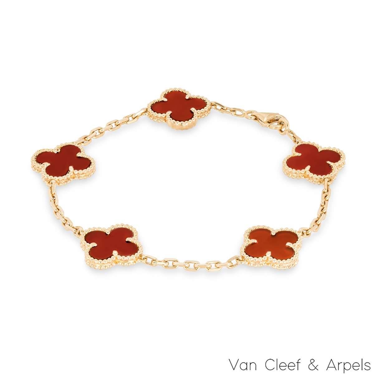 A lovely 18k yellow gold carnelian bracelet from the Vintage Alhambra collection by Van Cleef & Arpels. The bracelet features 5 iconic clover motifs, each set with a beaded edge and a carnelian inlay, set throughout the length of the chain. The