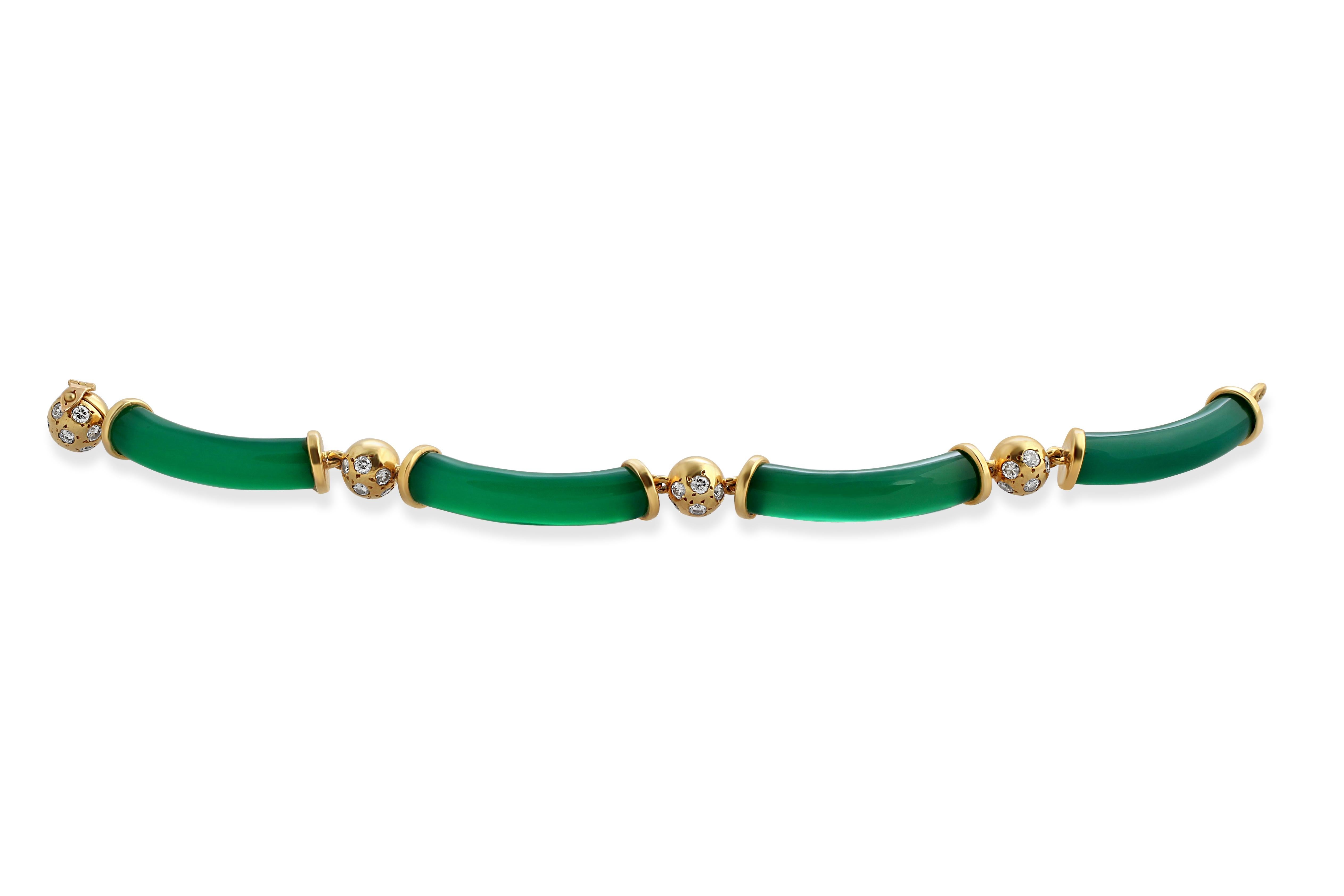 An 18k gold bracelet by Van Cleef & Arpels with four chalcedony links spaced with diamond set gold beads. Circa 1970s. Weight = 33gr.
