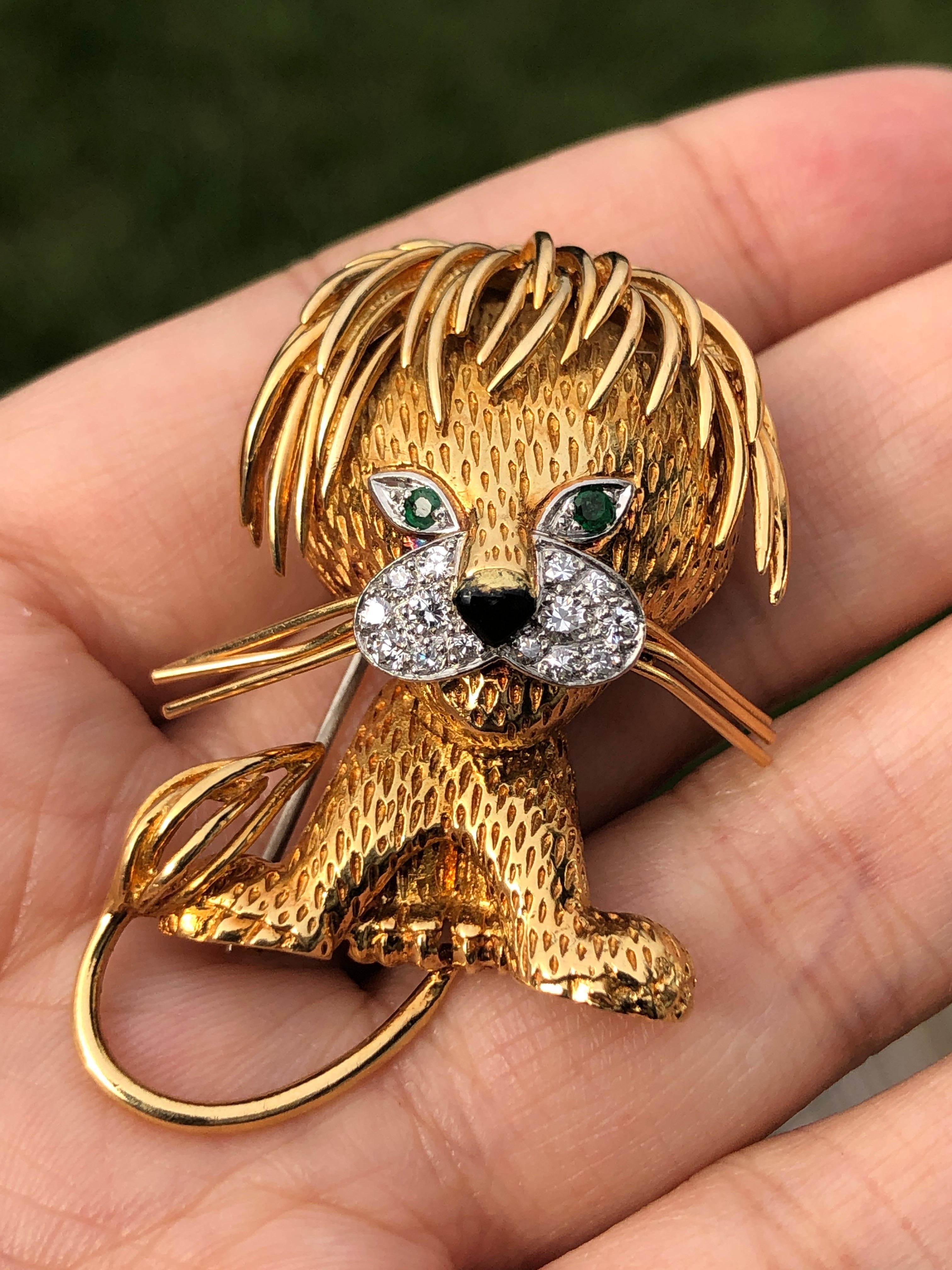 Circa 1970s Van Cleef and Arpels France 18K Yellow Gold Lion Clip brooch, measuring 4.6cm in length and 3cm wide. finely detailed, set with Emerald Eyes and Diamonds around the mouth and further decorated with a Black enamel nose.  This is the