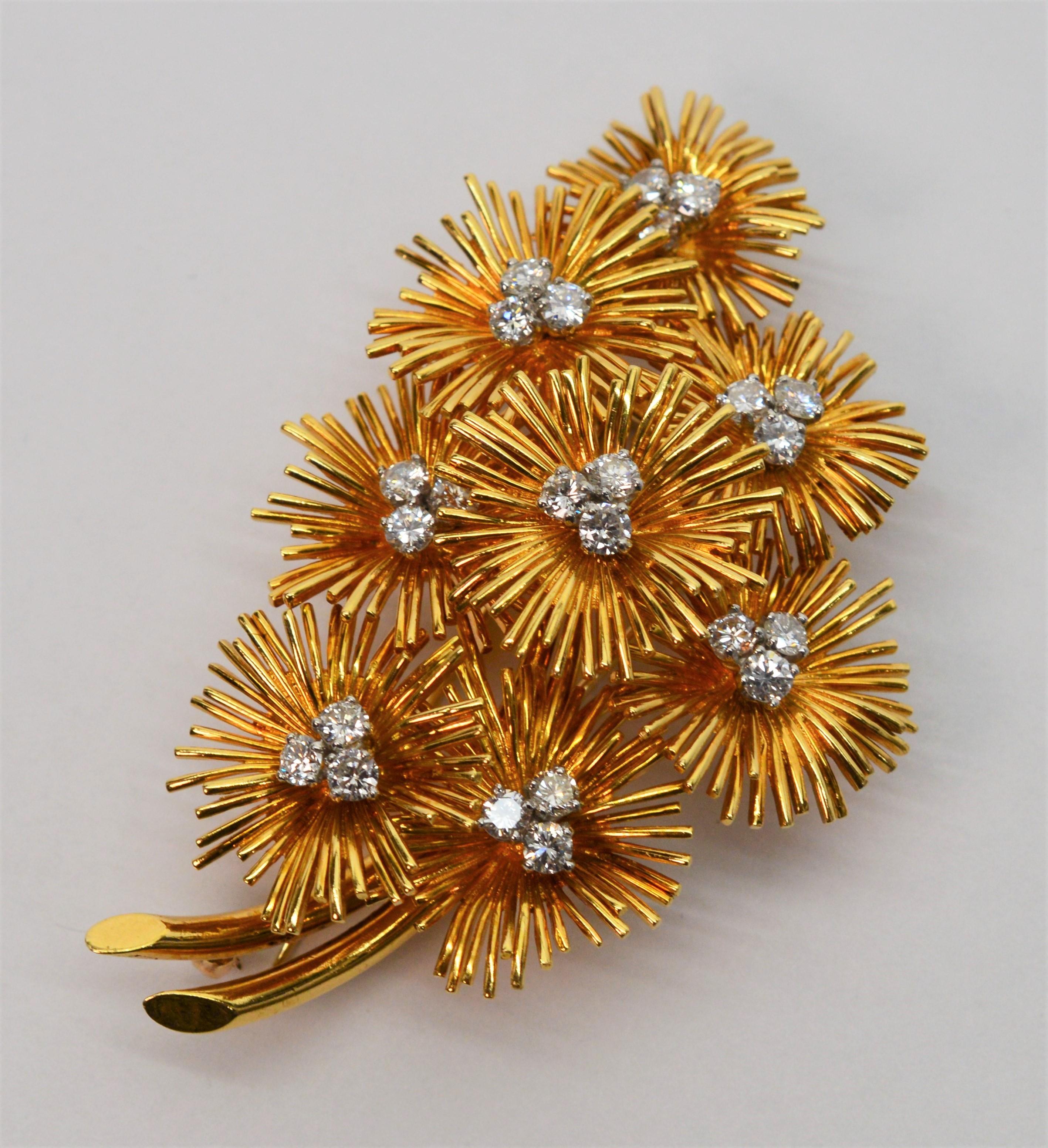 Three dimensional drama in eighteen karat 18K yellow gold and diamonds describes this stunning vintage Van Cleef & Arpels Brooch. Eight meticulously arranged floral bursts are expertly crafted in bright eighteen karat yellow gold creating elegant