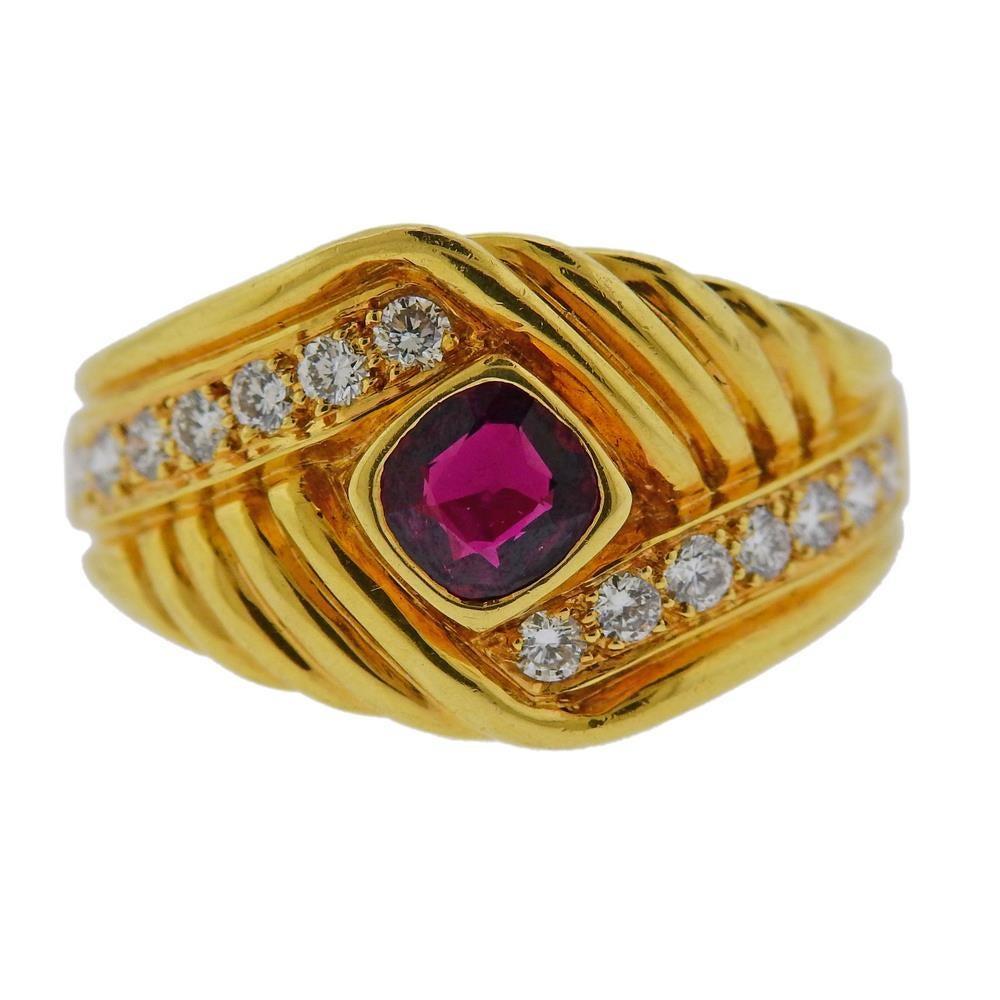 18k yellow gold ring by Van Cleef & Arpels. Set with ruby (5.4 x 5.4mm) and approx. 0.28ctw in diamonds. Ring size - 7.75, ring top is 15mm wide. Marked: Van Cleef & Arpels,NY 5k 531-1. Weight 11.4 grams.