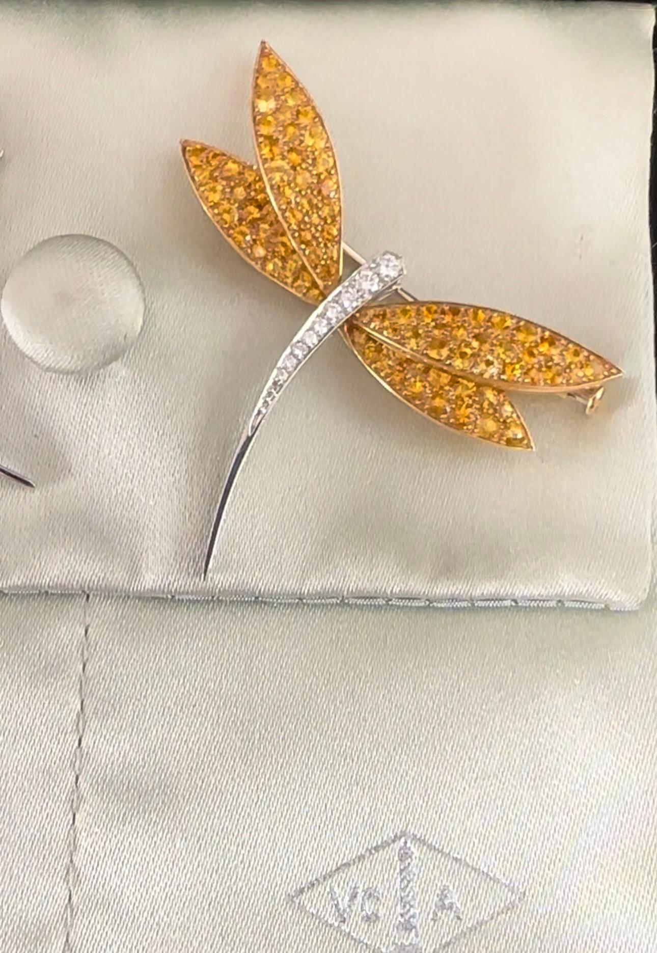 The VAN CLEEF & ARPELS Dragonfly Clip 
 Description: White gold and 18k Yellow Gold Dragonfly Clip Featuring Yellow Sapphires and Diamonds.
Specifications:

Gemstones: Yellow Sapphires Est 2.50 cts 
Diamonds. .10 cts 
Design: Dragonfly
