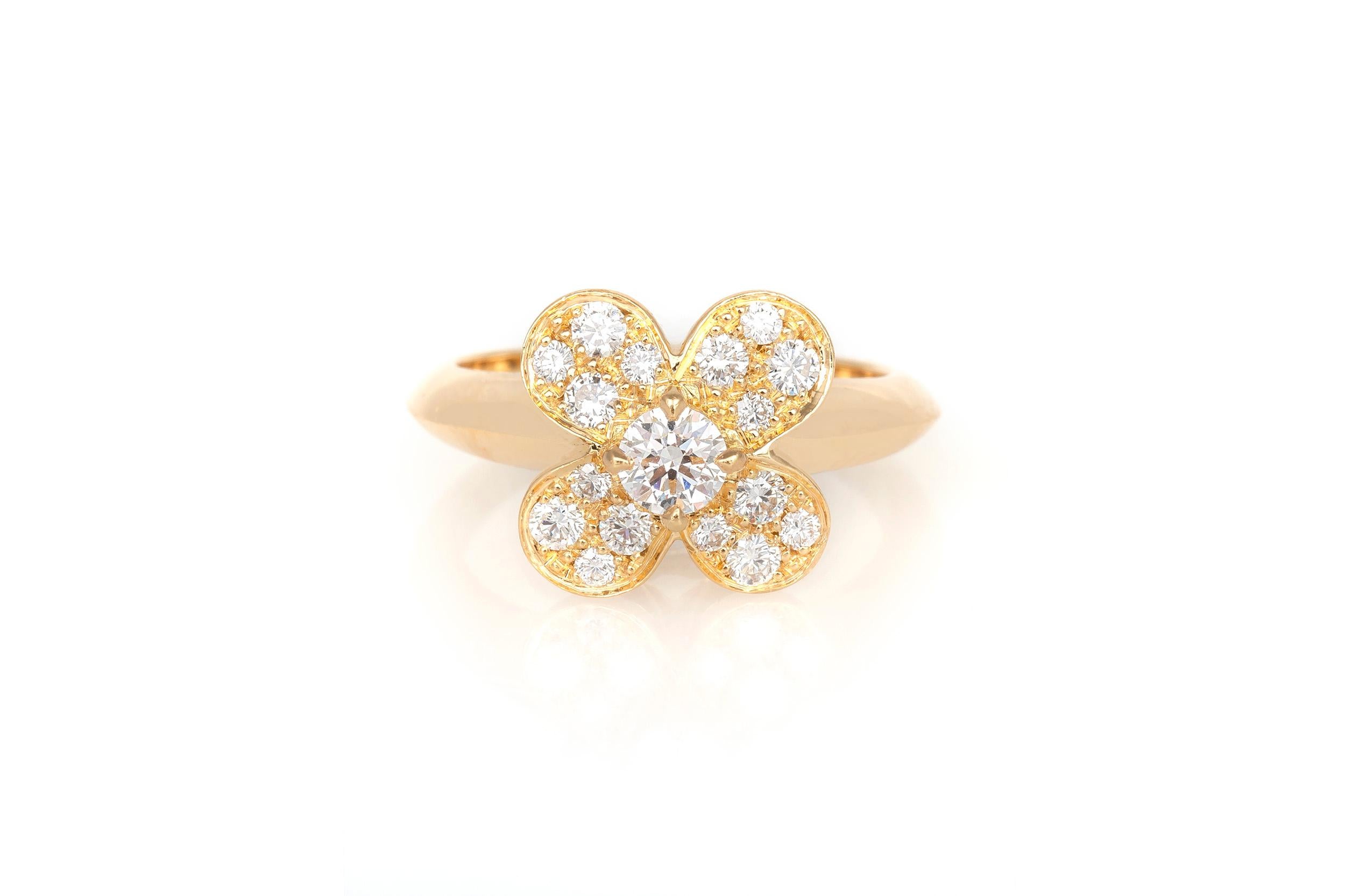 Finely crafted in 18K yellow gold with a round brilliant diamond at the center of the flower, and 4 small brilliant round diamonds on each petal.
Signed by Van Cleef & Arpels
Size 5 1/2, resizable