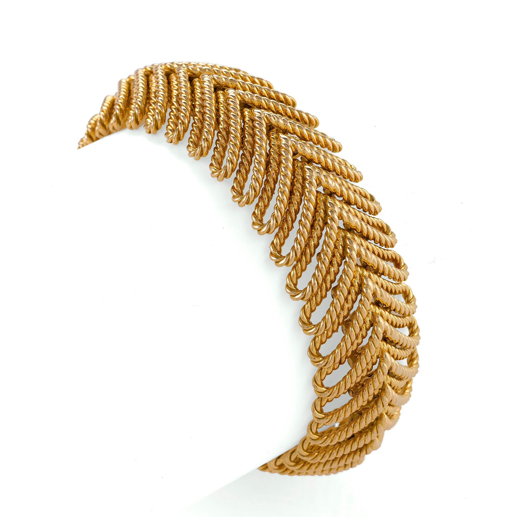 Made in the 1960s, this Van Cleef & Arpels Paris gold ropetwist bracelet is composed of a symmetrical line of flexible, gently-looping open links. Soft, flexible and richly textured, with a sense of airy 1960s freedom, this bracelet exudes warmth