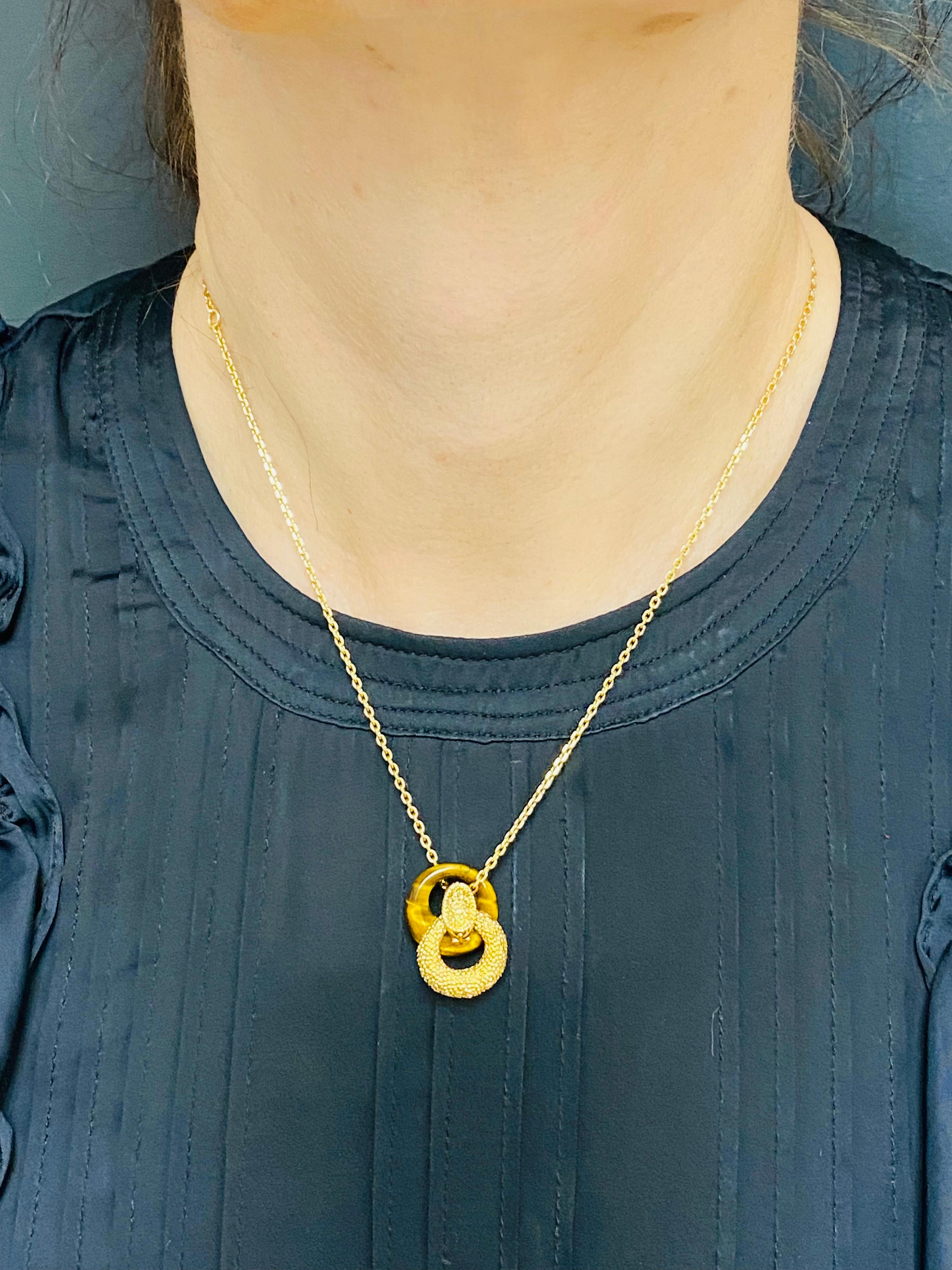 DESIGNER: Van Cleef & Arpels
CIRCA: 1980
MATERIALS: 18K Yellow Gold
GEMSTONE: Tiger’s Eye
WEIGHT: 12.3 grams
MEASUREMENTS: The chain’s length is 17”, the diameter of pendant is 10/16