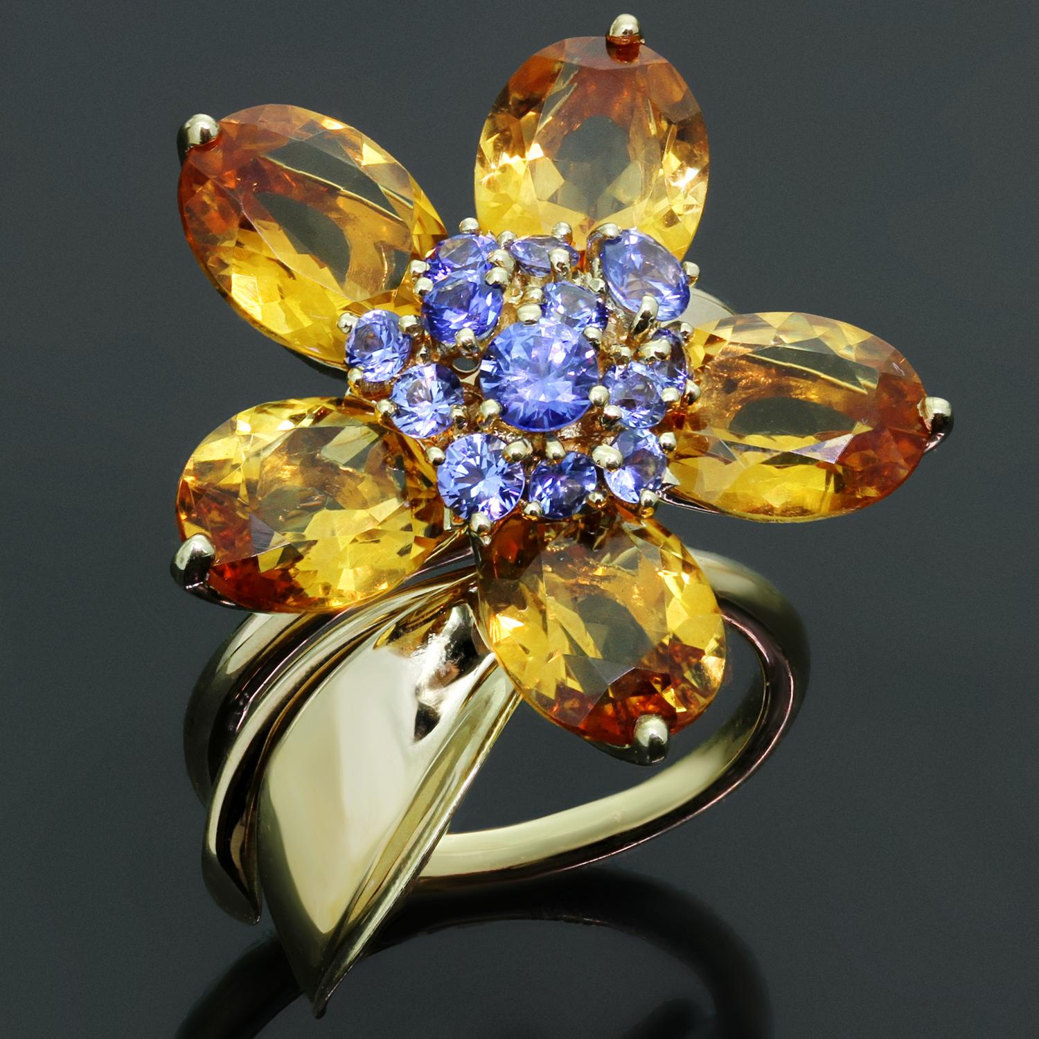 This stunning Van Cleef & Arpels ring from the gorgeous Hawaii collection is crafted in 18k yellow gold and features an open band accented with a leaf and a rotatable flower composed of 5 faceted citrine petals weighing an estimated 12.5 carats and