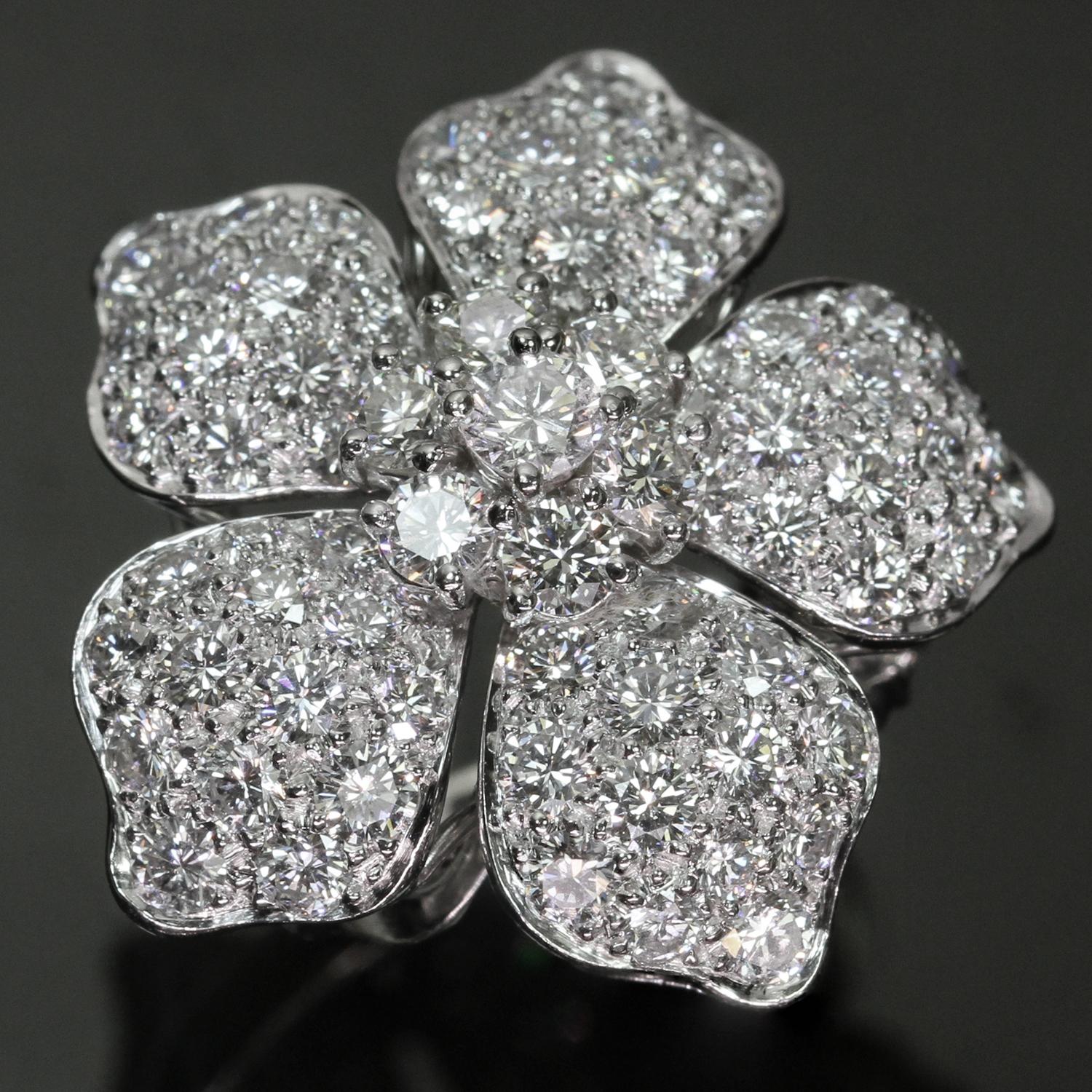 This fabulous rare authentic Van Cleef & Arpels ring from the gorgeous Hawaii collection features a flower design crafted in platinum and set with approximately 67 diamonds on petals and 7 diamonds in the center. The round brilliant VVS1-VVS2