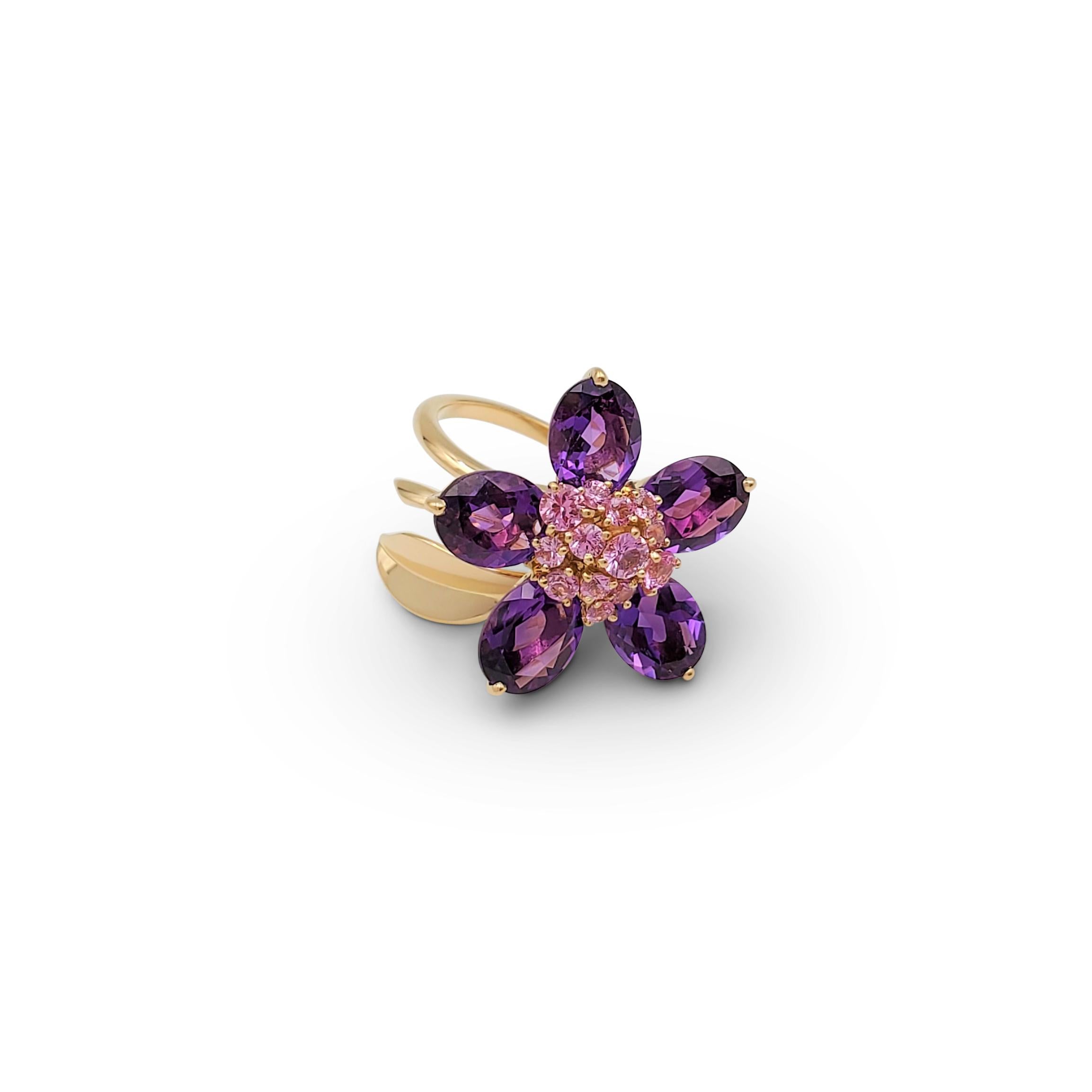 Authentic vibrant Van Cleef & Arpels ring from the 'Hawaii' collection. Designed as a rotating flower, the center is set with round graduated pink sapphires weighing an estimated 1.00 carats total. Five pear-shaped amethyst petals weighing an