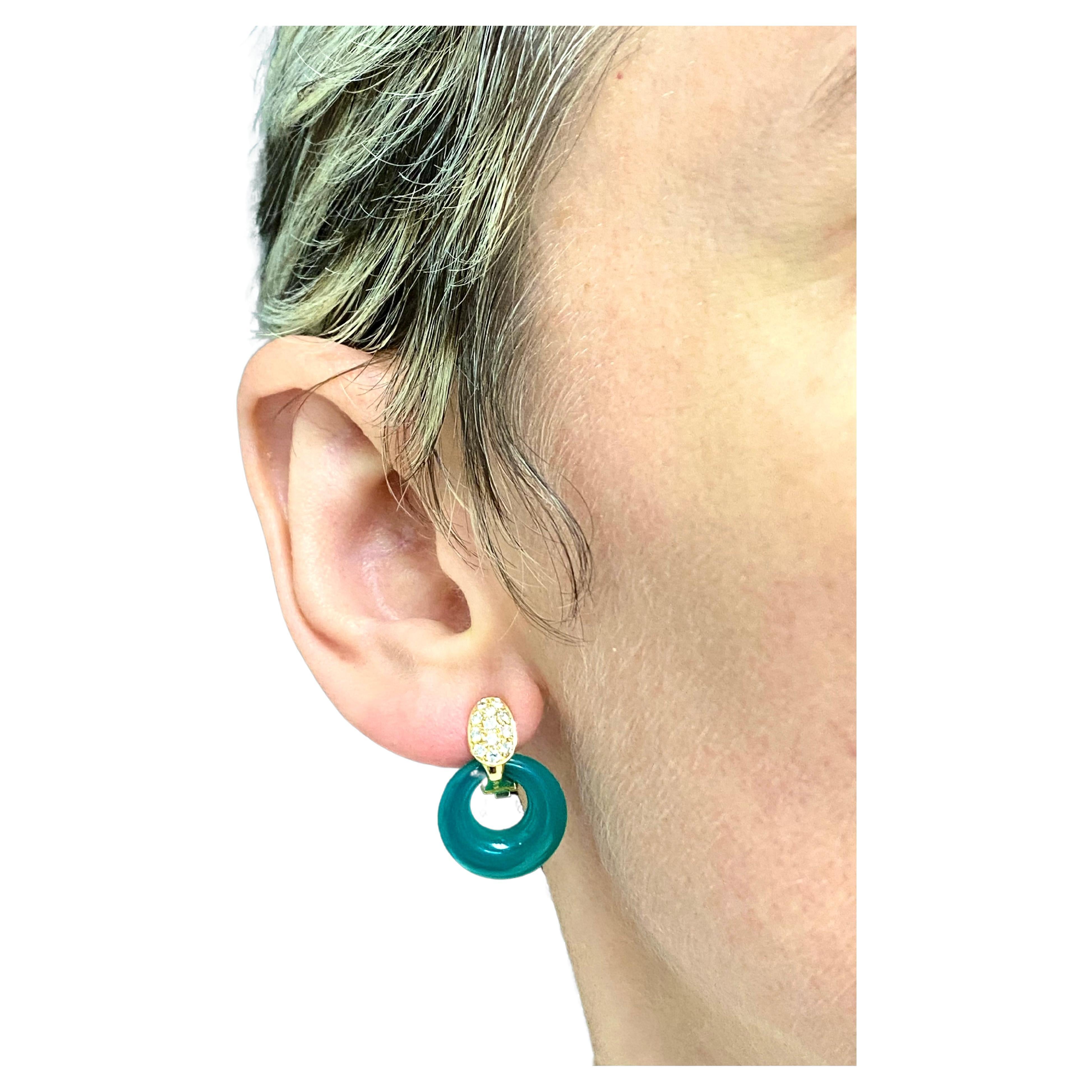 
A set of interchangeable Van Cleef & Arpels earrings made of 18k gold, featuring diamond, jade and chrysoprase. The earrings comprise the gold and diamond part and three removable doorknocker disks: one with diamonds and two made of the gemstones.