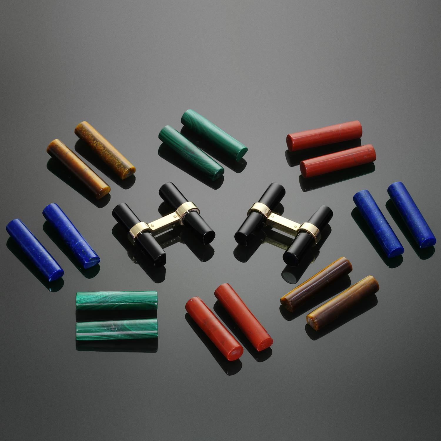 This exquisite and rare vintage Cartier bar cufflinks set is crafted in 18k yellow gold and comes with 5 sets of interchangeable batons composed of Black Onyx, Lapis Lazuli, Tiger's Eye, Jasper, and Malachite. Made in France Measurements: 0.86