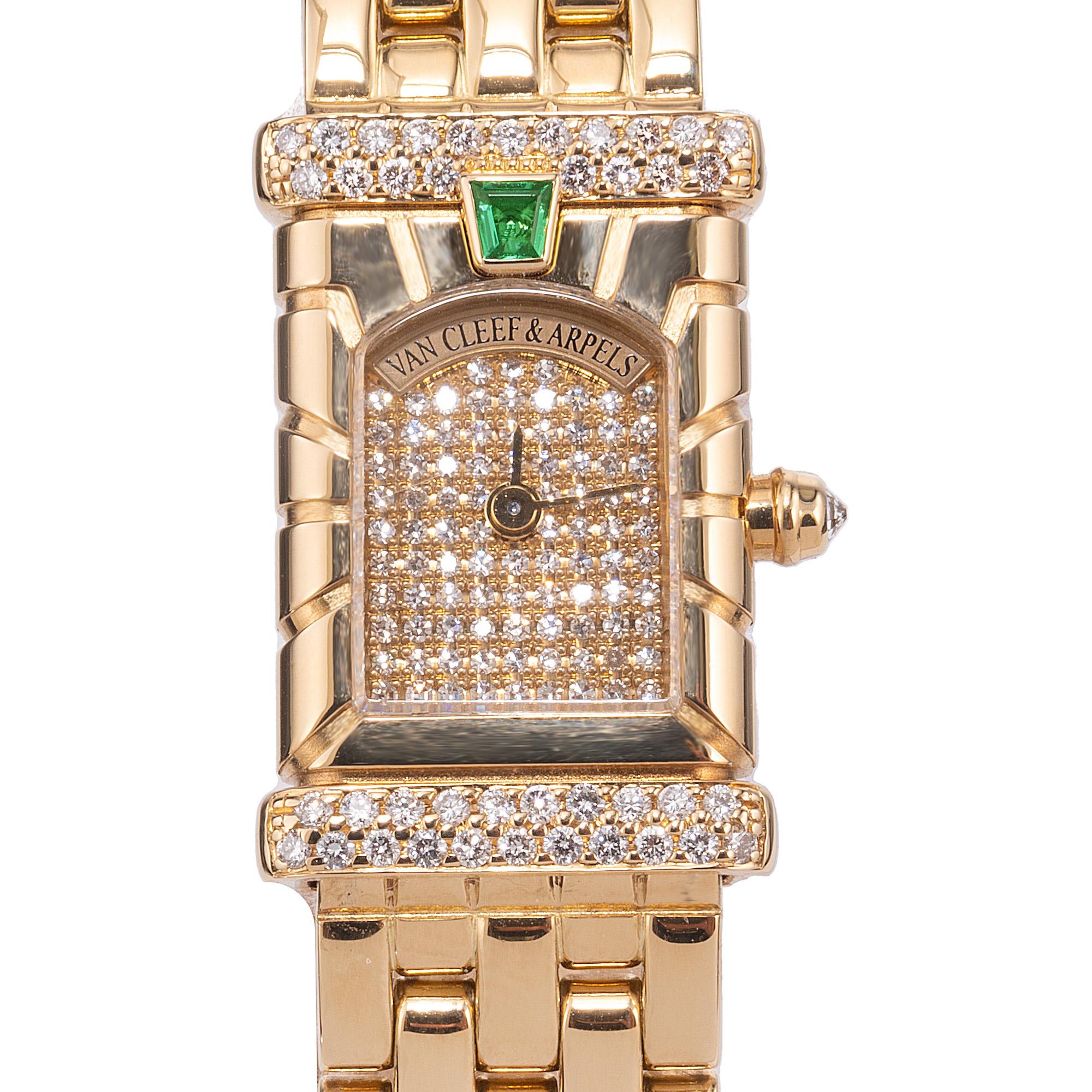 The Van Cleef & Arpels Ladies Diamond Emerald Yellow Gold Wristwatch is an exquisite blend of timeless elegance and modern artistry. This luxurious timepiece sparkles with an array of delicately set diamonds that dance with light, while vibrant