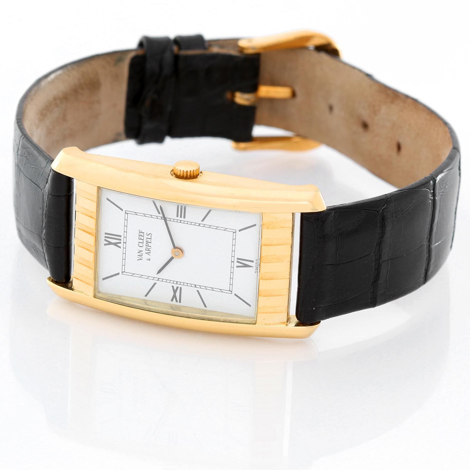 Van Cleef & Arpels Classic Yellow Gold Ladies Watch - Quartz. 18K Yellow gold ( 21mm x 38 mm). Flat white dial with stick hour markers and Roman numeral markers at 12, 3, 6, and 9 o'clock. Black Alligator Strap with Tang Buckle. Pre-owned with