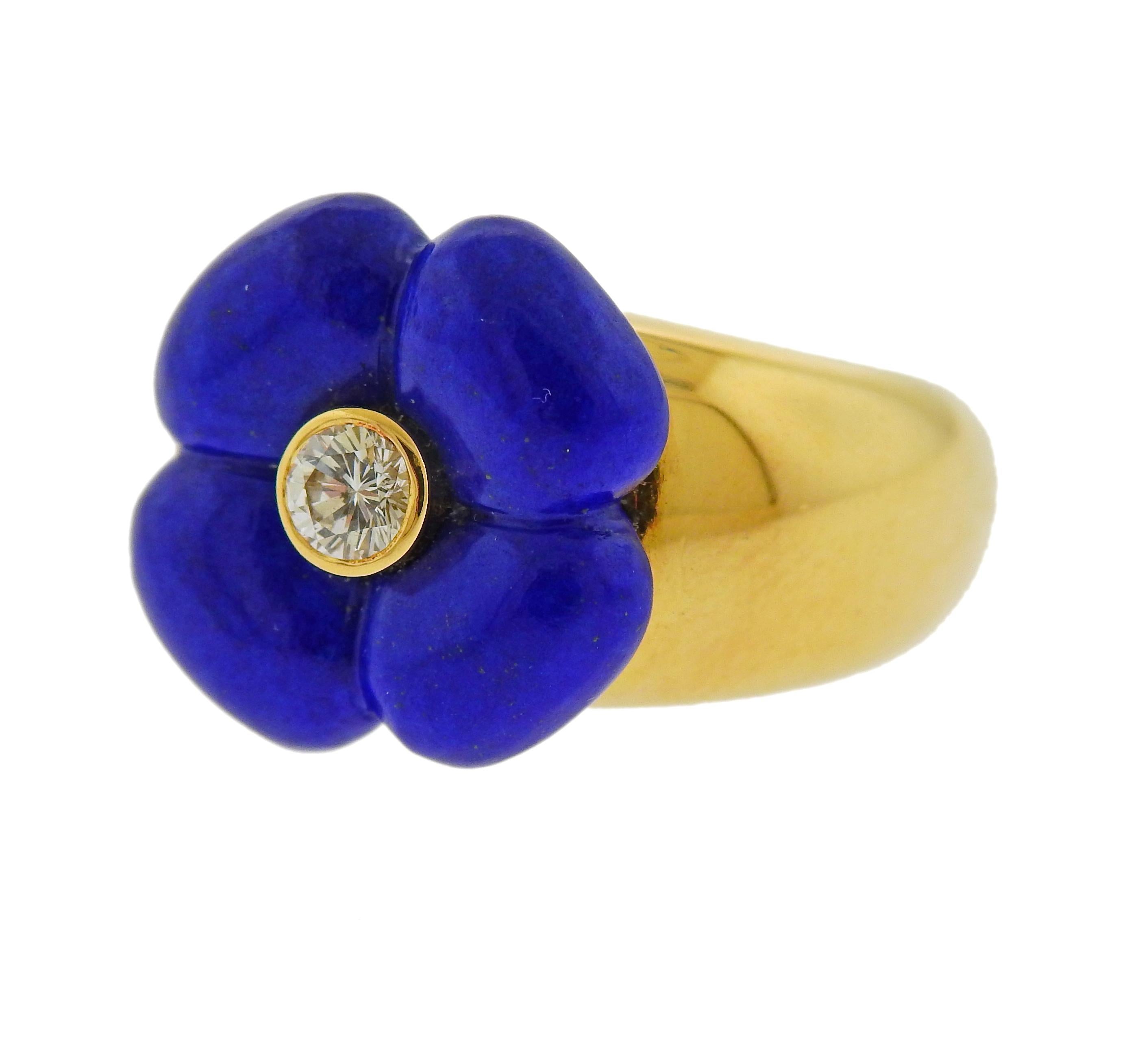 18k yellow gold flower ring by Van Cleef & Arpels, set with carved lapis lot and an approx. 0.20ct VVS/FG diamond in the center. Ring size - 6.25, ring top - 15mm x 15mm. Weight is 12.8 grams. Marked French marks, VCA, 18kt, 750, B5873 L1. 