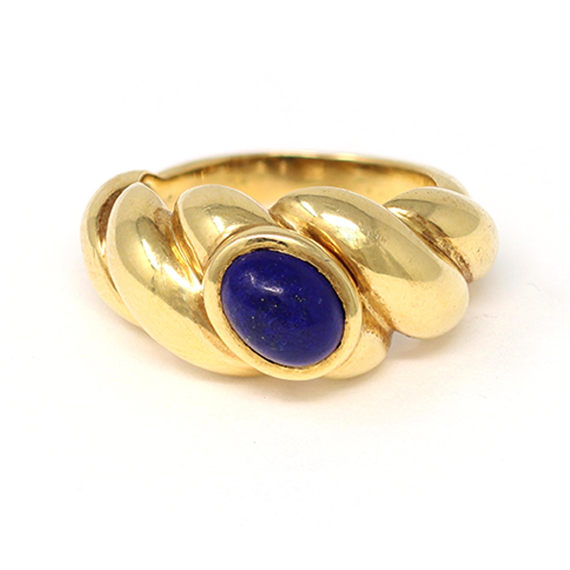 The French house of jewelry Van Cleef & Arpels signs the oval Cabochon Lapis Lazuli ring. The ring is shaped like a torsade and styled in 18 Karat yellow gold. It is signed and numbered and has a gross weight of 7.4 grams. It fits a size 4 and