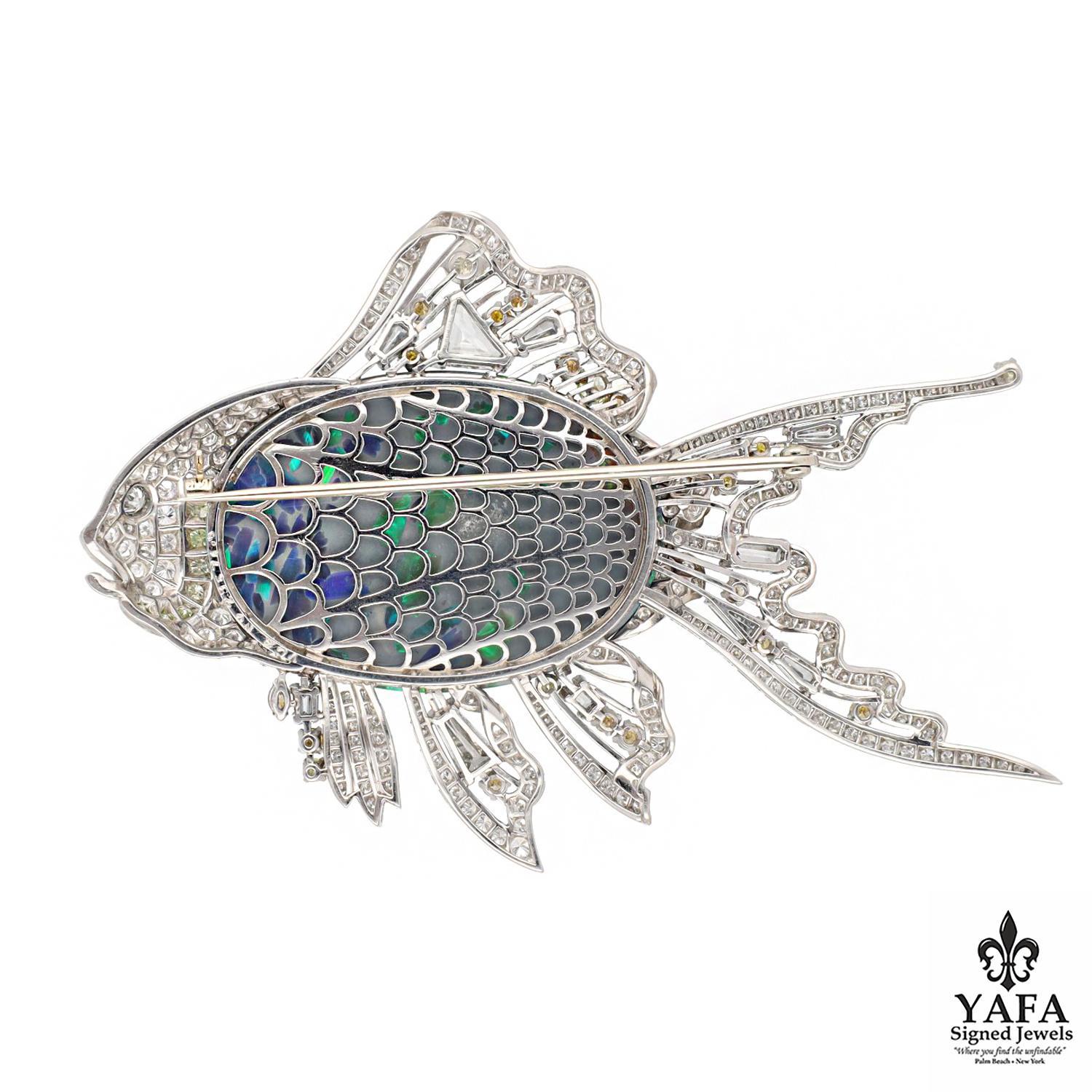 A Masterstroke of Creativity with an Explosion of Color, this Van Cleef & Arpels Brooch Expresses its Design Through a Vibrant Oval Shaped Black Opal Reminiscent of the Caribbean Sea, Further Enhanced with White and Fancy Colored Diamonds in Various