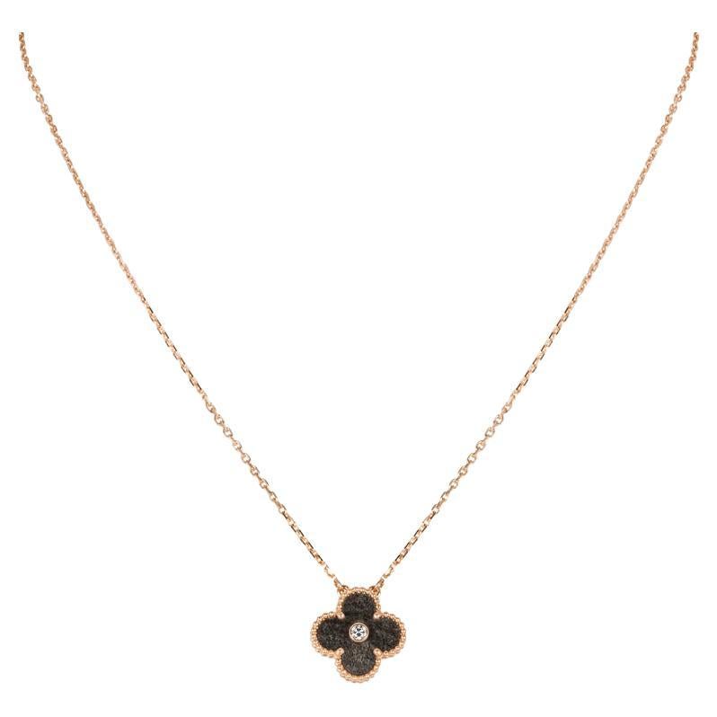 A limited edition 18k rose gold obsidian and diamond Van Cleef & Arpels Vintage Alhambra pendant from the 2023 Holiday collection. The pendant features a beaded edge 4 leaf clover motif with an obsidian inlay. Further complementing the obsidian