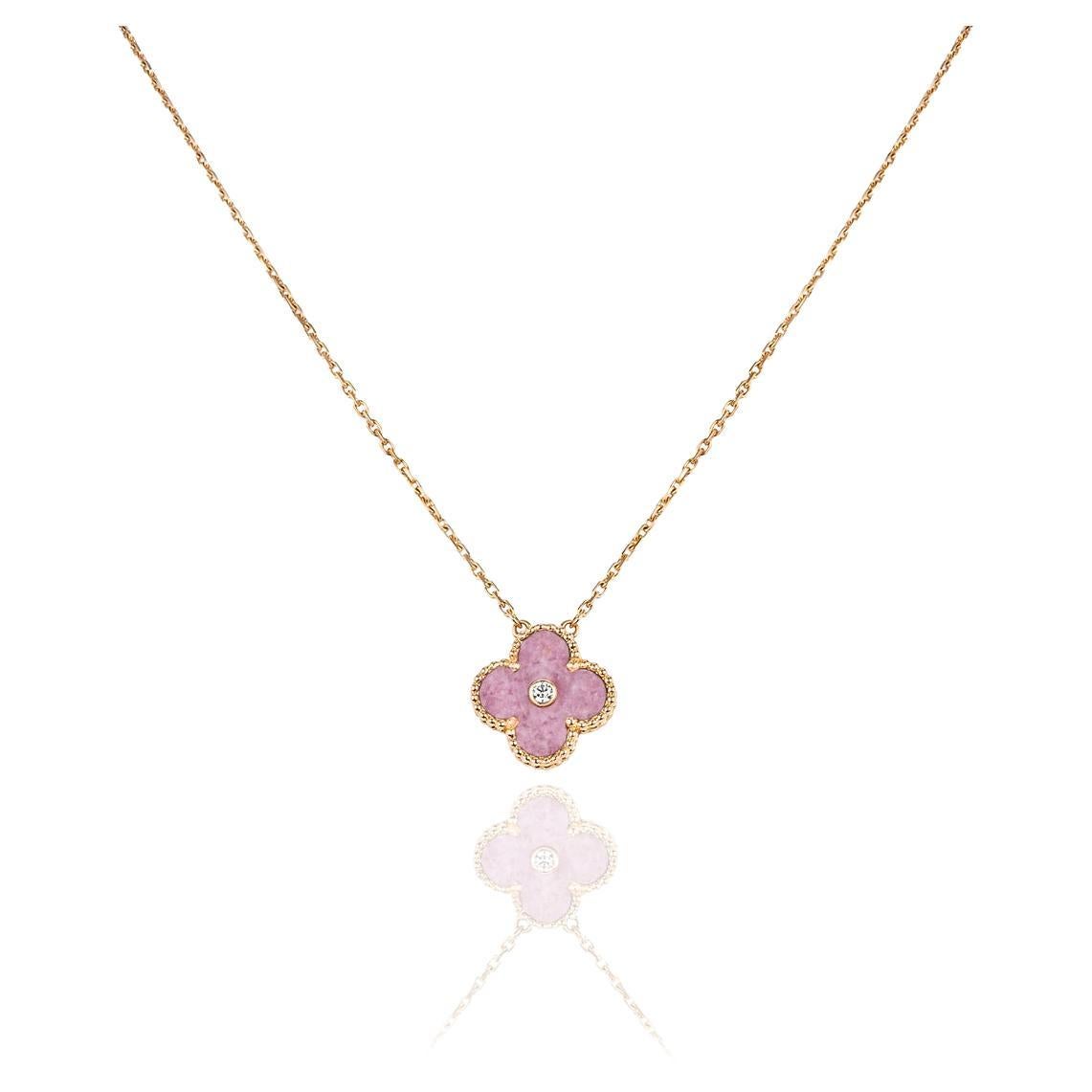 A limited edition 18k rose gold rhodonite and diamond Van Cleef & Arpels Vintage Alhambra pendant from the 2021 Holiday collection. The pendant features the iconic beaded edge 4-leaf clover motif with a rhodonite inlay. Complementing the inlay is a