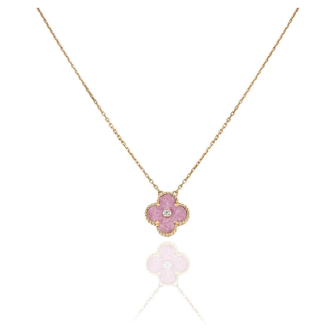 A limited edition 18k rose gold rhodonite and diamond Van Cleef & Arpels Vintage Alhambra pendant from the 2021 Holiday collection. The pendant features a beaded edge 4 leaf clover motif with a rhodonite inlay. Further complementing the inlay is a