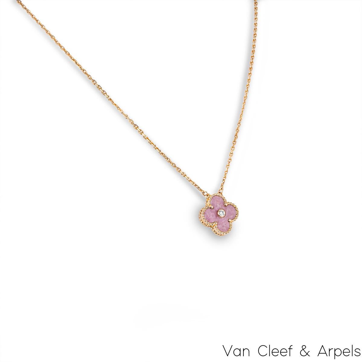 A limited edition 18k rose gold rhodonite and diamond Van Cleef & Arpels Vintage Alhambra pendant from the 2021 Holiday collection. The pendant features a beaded edge 4 leaf clover motif with a rhodonite inlay. Further complementing the inlay is a