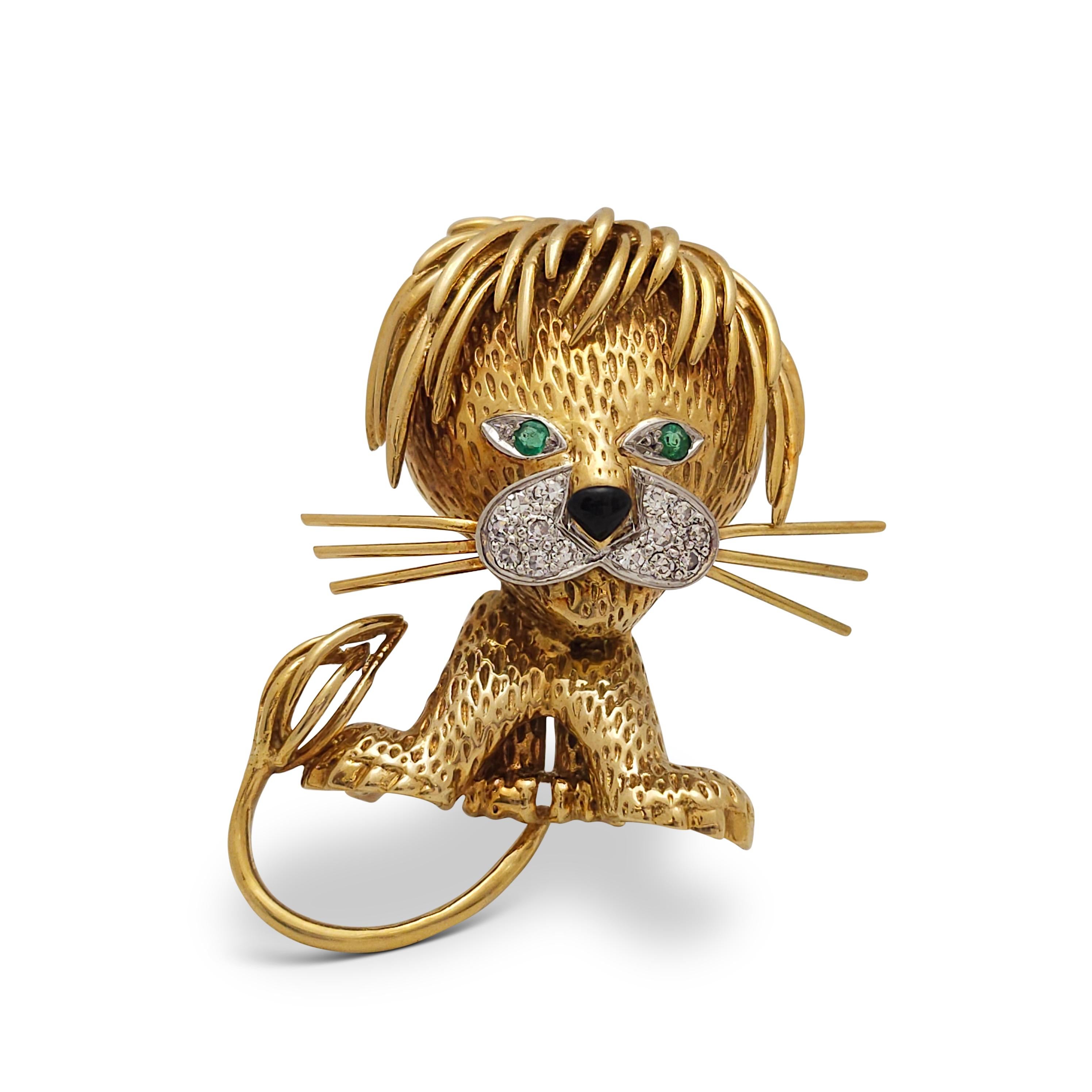 Authentic Van Cleef & Arpels 'Lion Ebouriffé' brooch crafted in 18 karat yellow gold. The iconic design depicts a lion with a playfully tousled mane, lively emerald eyes, onyx nose, and diamond muzzle of approximately .14 carats total. The brooch