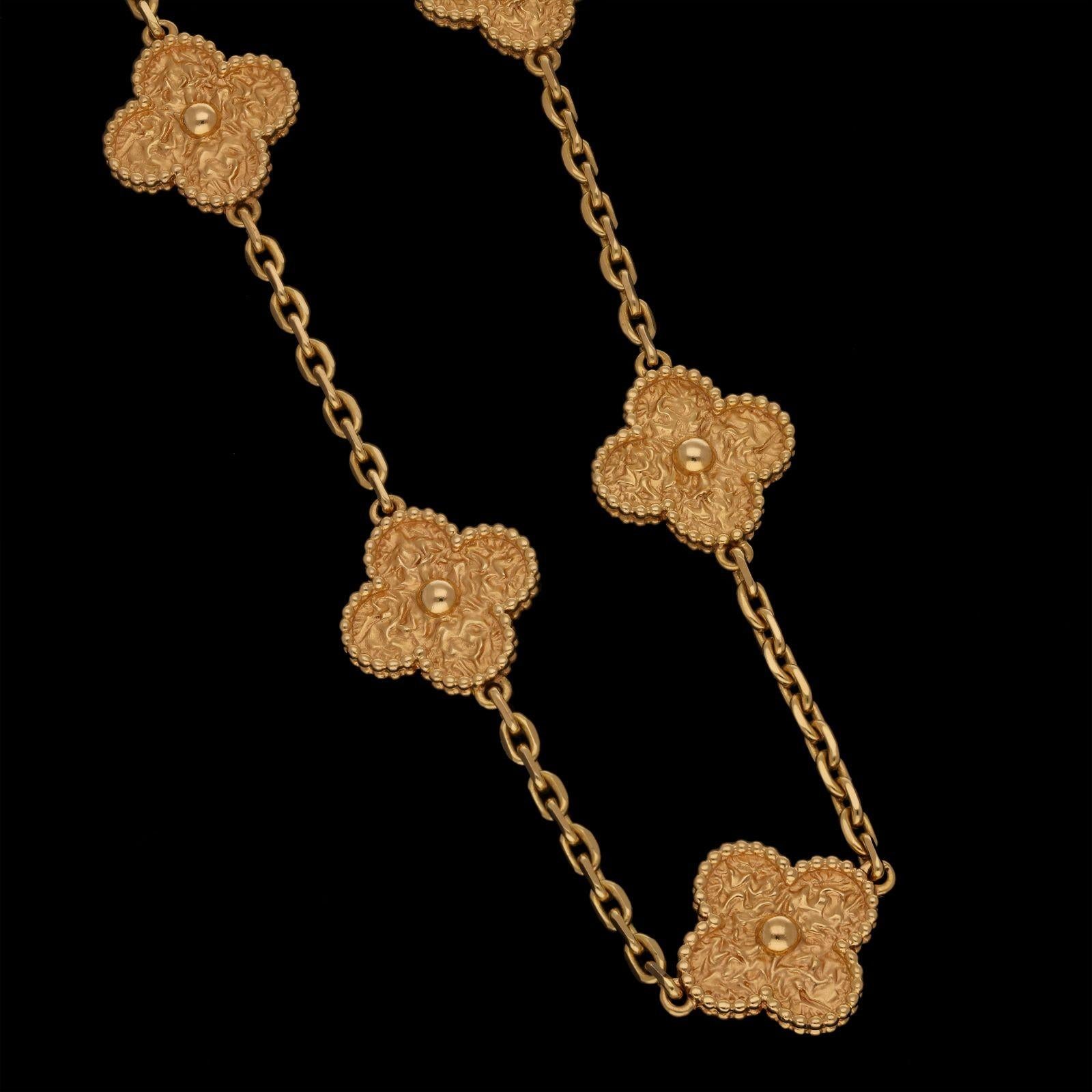 A rose gold Alhambra necklace by Van Cleef & Arpels, 2014, the 33.5” necklace features twenty textured double sided clover motifs in 18ct rose gold with a beaded border, joined by oval links with flattened edges to a lobster clasp. The Alhambra