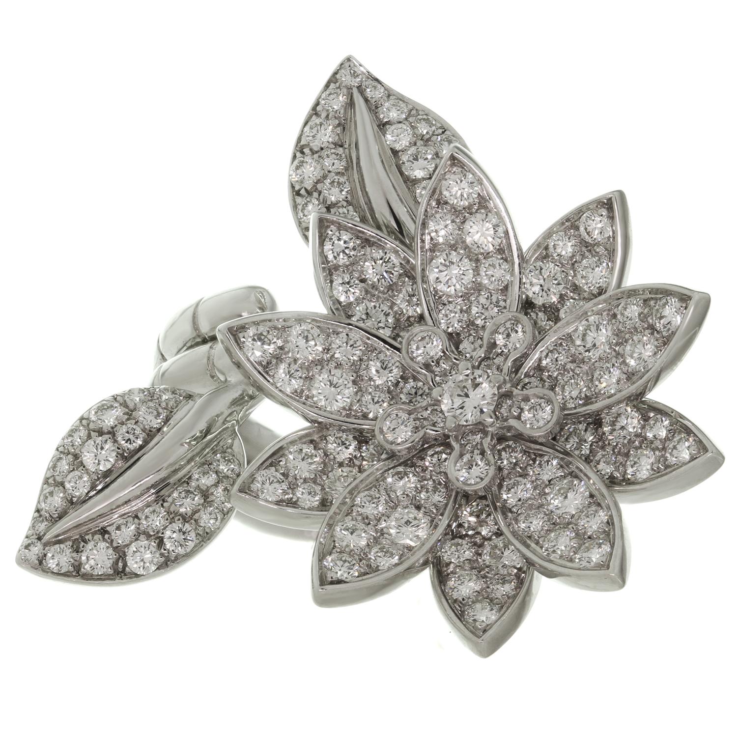 This fabulous Van Cleef & Arpels ring is crafted in 18k white gold and features a gorgeous lotus flower design set with 127 brilliant-cut round D-E VVS1-VVS2 diamonds of an estimated 2.20 carats. This between-the-finger ring can be worn on either
