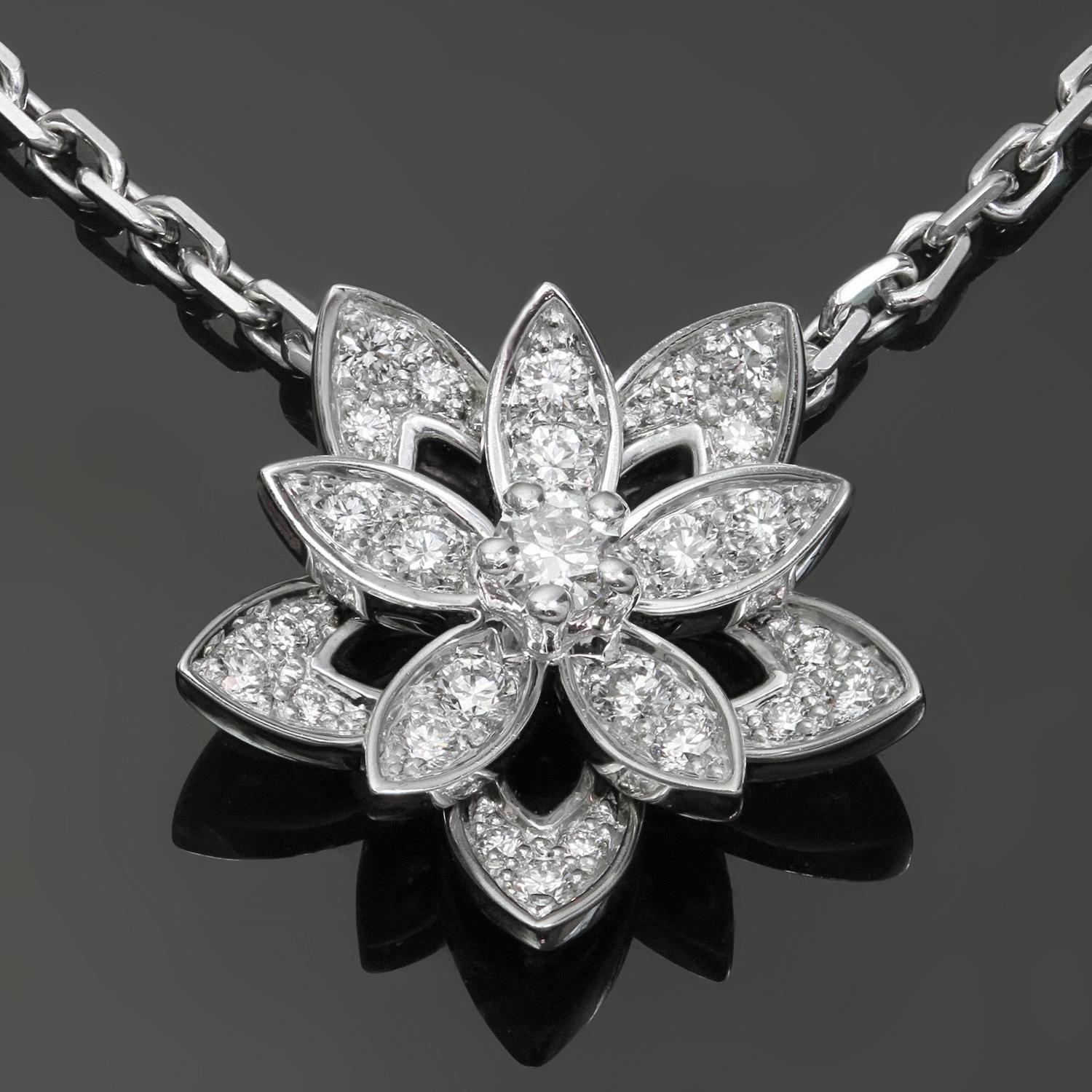 This gorgeous Van Cleef & Arpels necklace is crafted in 18k white gold and features an openwork lotus pendant set with 26 round brilliant D-F VVS1-VVS2 diamonds weighing an estimated 0.16 carats. This is the mini model of the pendant. Made in France