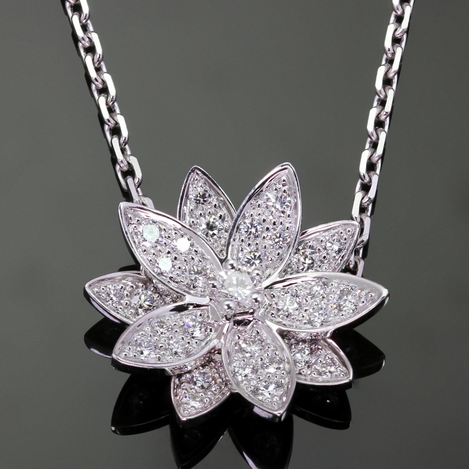 This gorgeous authentic Van Cleef & Arpels necklace features a lotus flower crafted in 18k white gold and set with 31 round brilliant D-E-F VVS1-VVS2 diamonds weighing an estimated 0.46 carats. The pendant is attached to the chain. Made in France