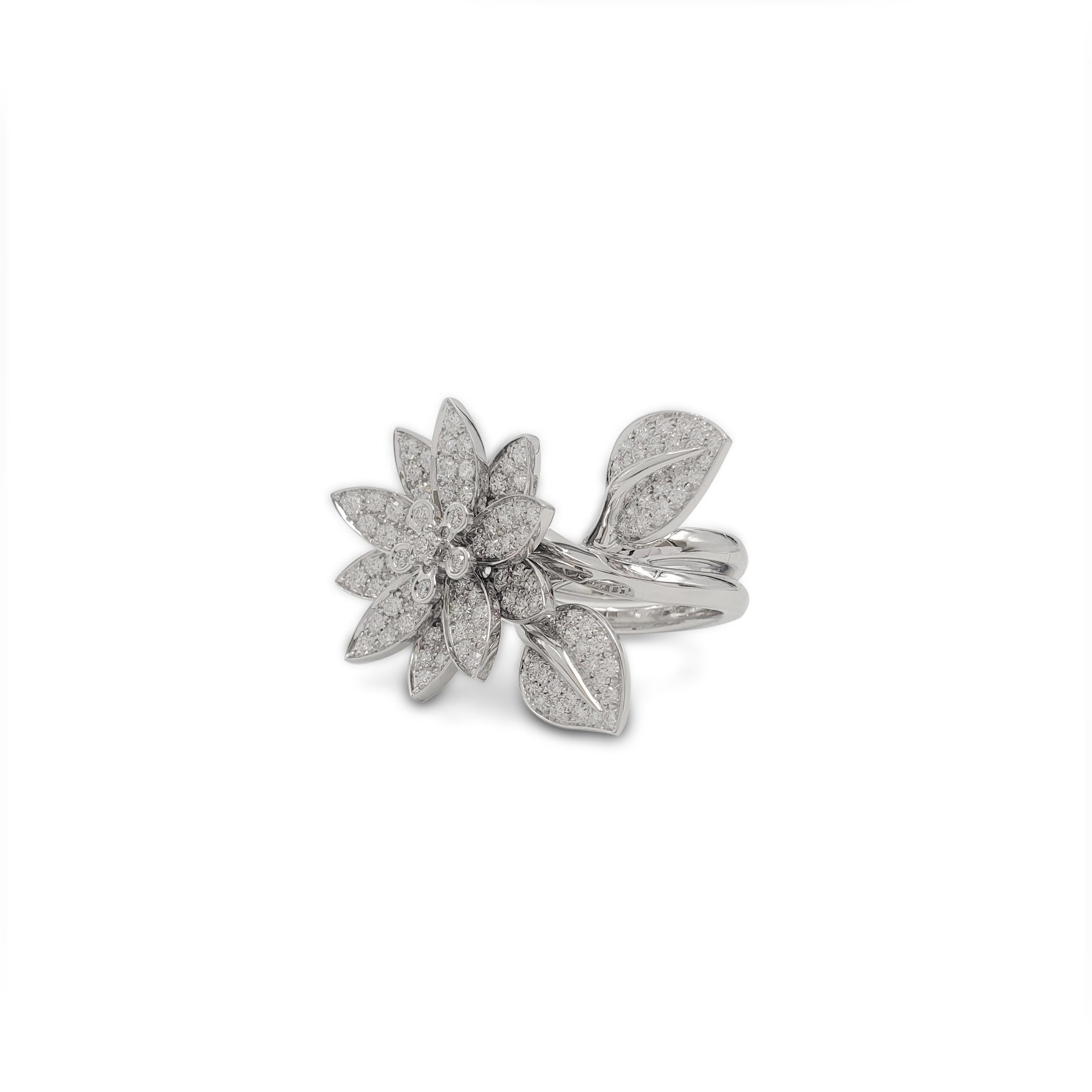 Authentic Van Cleef & Arpels 'Lotus' ring crafted in 18 karat white gold. This ring is comprised of a flower and two leaves that are pave set with sparkling round brilliant cut (G color, VS clarity) diamonds weighing an estimated 2.10 carats total.
