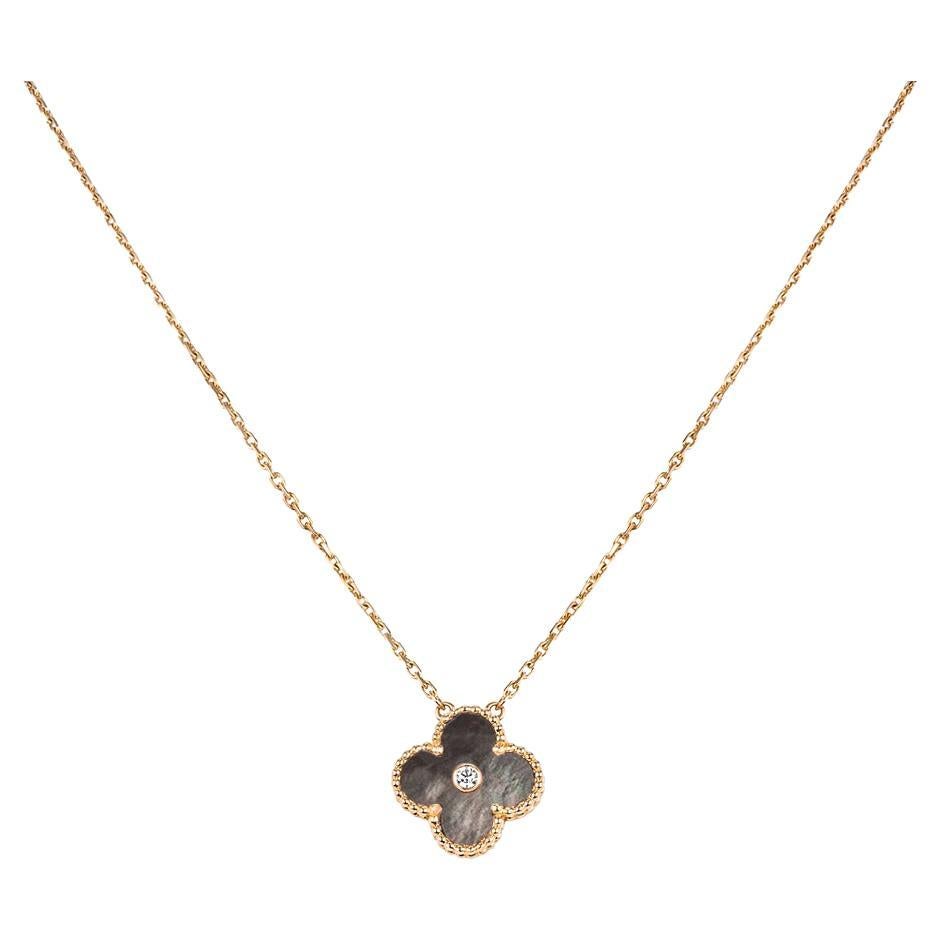 A limited edition 18k rose gold grey mother of pearl and diamond Van Cleef & Arpels Vintage Alhambra pendant from the 2014 Holiday collection. The pendant features a beaded edge 4 leaf clover motif with a grey mother of pearl inlay. Further