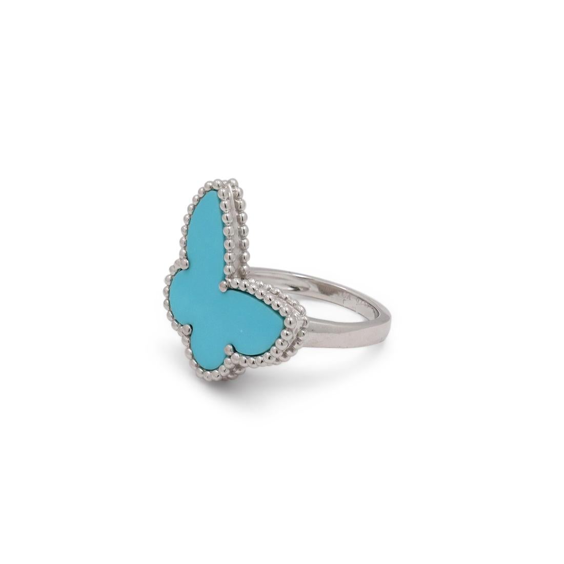Authentic Van Cleef & Arpels 'Lucky Alhambra' ring crafted in 18 karat white gold and featuring a turquoise butterfly motif. Signed VCA, Au750 with serial number. Ring size 50 (US 5 1/4). The ring is presented with the original Van Cleef & Arpels