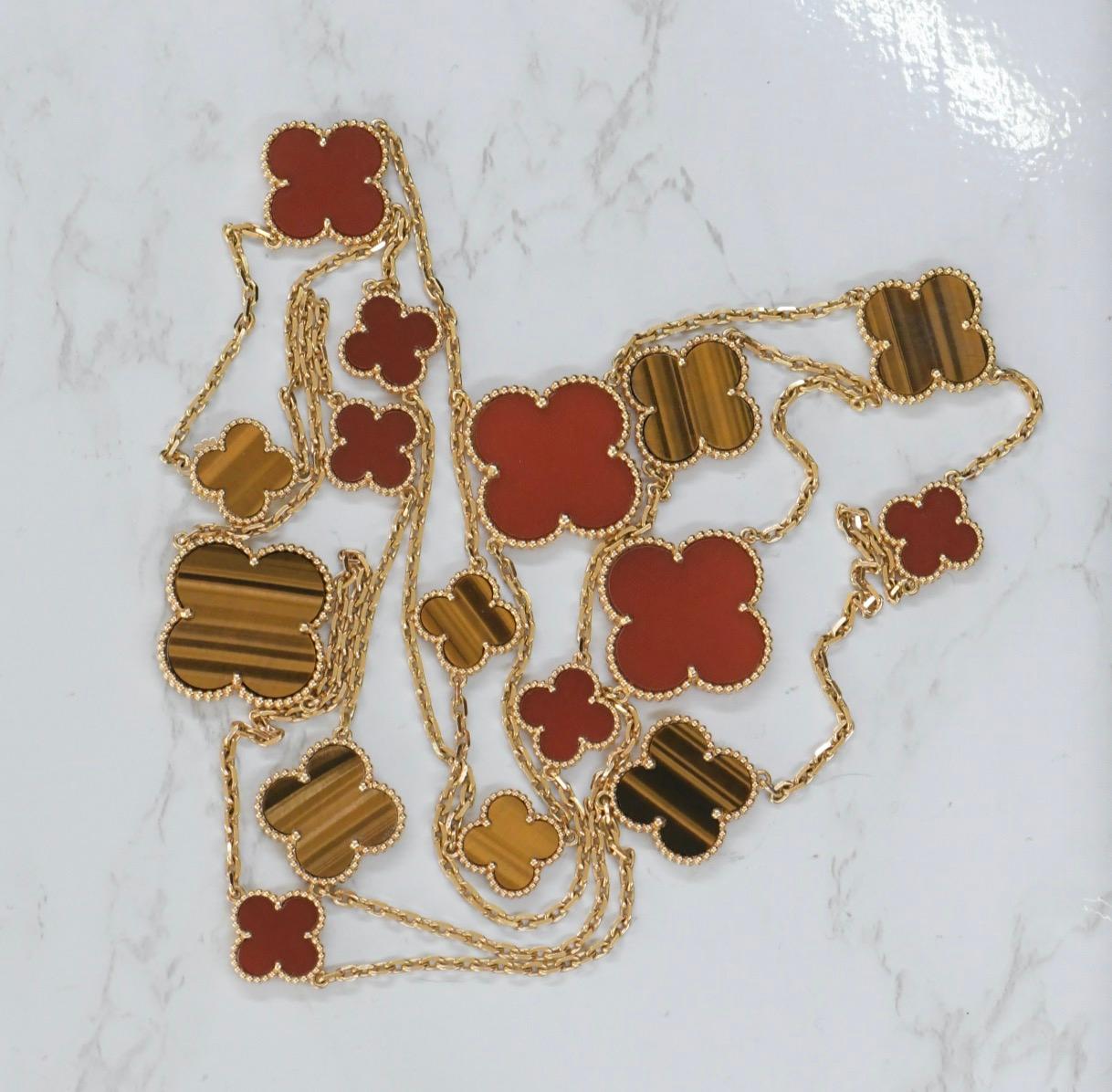 Very Rare Van Cleef & Arpels 18k Gold Tiger Eye Carnelian 16 Motif Magic Alhambra Necklace. This necklace comes with a Van Cleef & Arpels Box 

Dandelion Antiques Code	AT-1957
Brand	                                Van Cleef & Arpels
Model	          