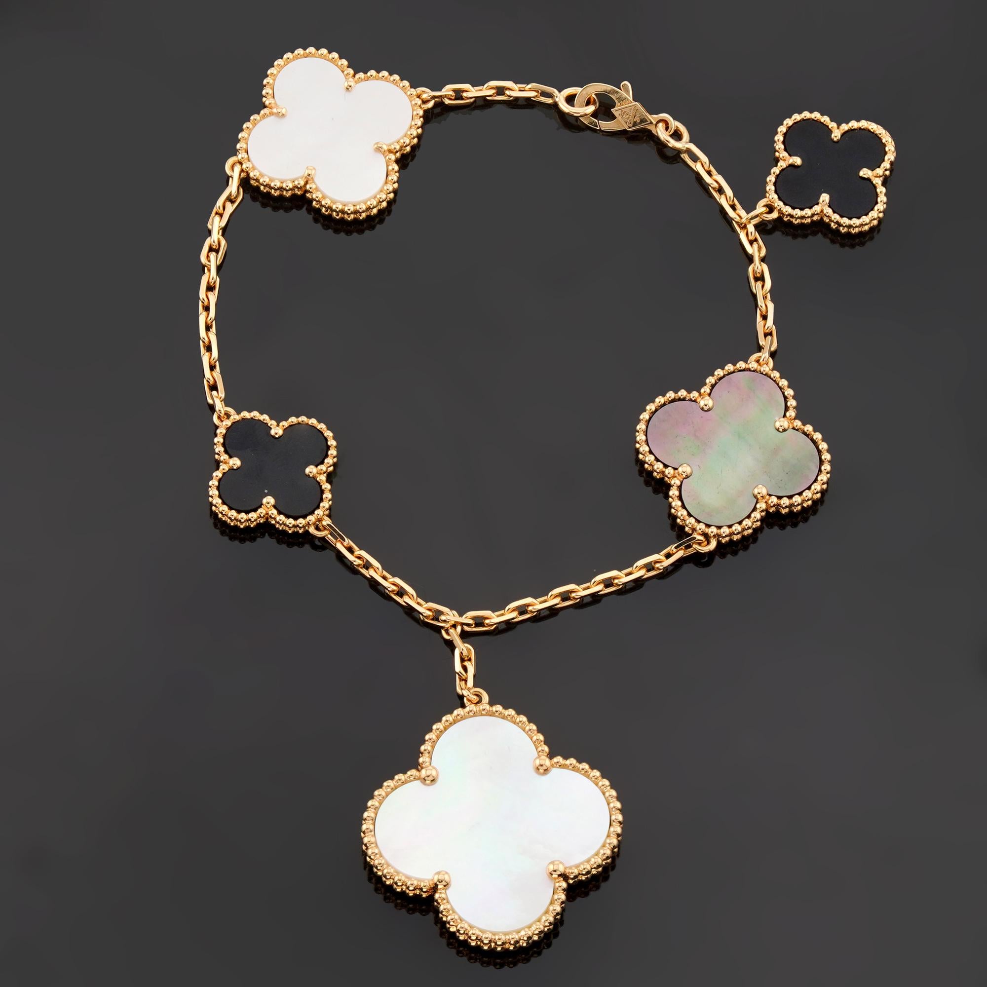 This fabulous Van Cleef & Arpels bracelet from the Magic Alhambra collection is crafted in 18k yellow gold and features 5 lucky clover motifs, 3 inlaid with mother-of-pearl and 2 inlaid with black onyx. Made in France circa 2024. Measurements: 1.02